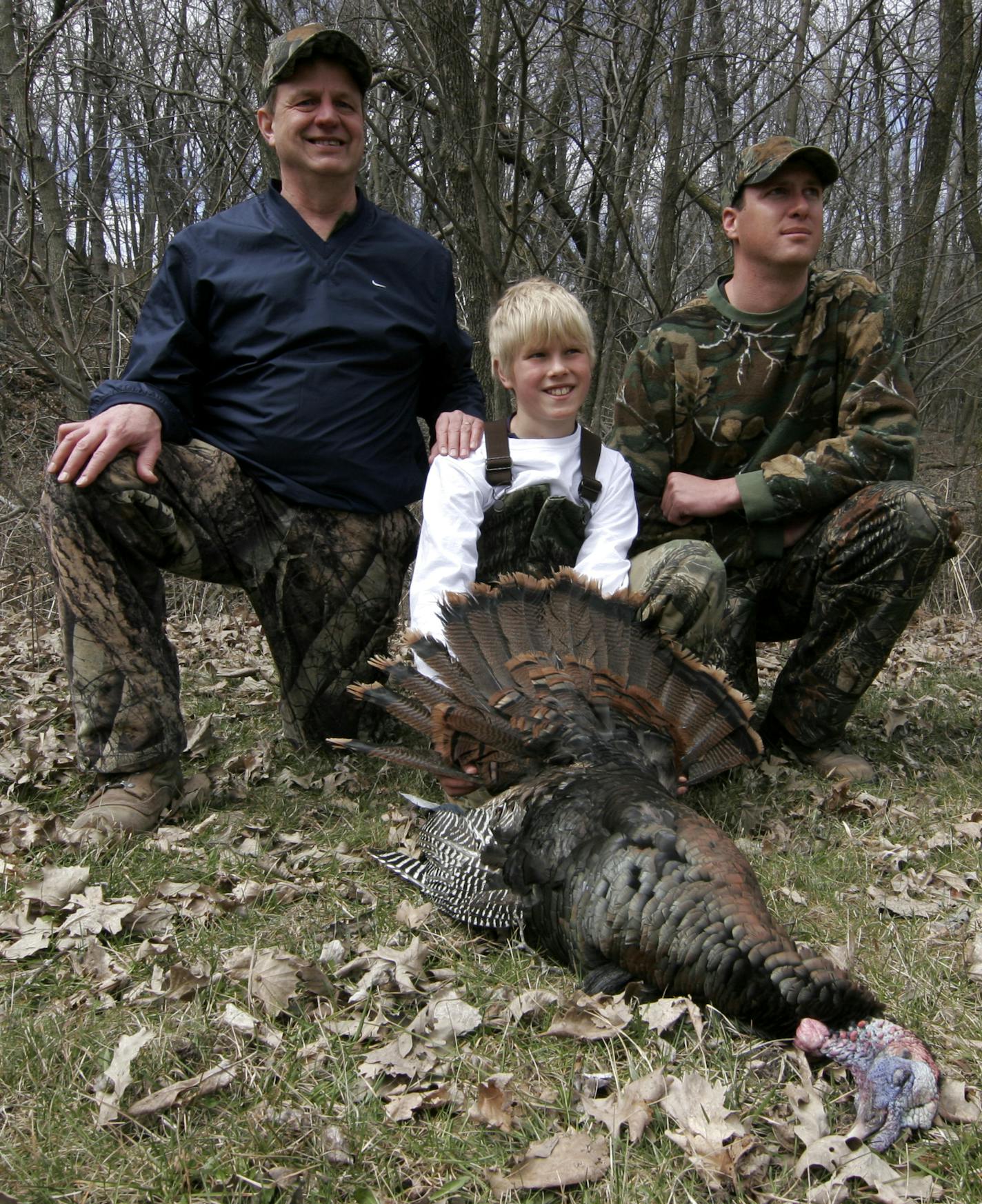 Doug Smith/Star Tribune; April 19, 2008; near Morton, Minn.. Griffin Schaub, 12, of Danube, Minn., proudly displayed his first-ever turkey, bagged Saturday during a youth turkey hunt near Morton in southwestern Minnesota. With him is his dad, Randy, left, and guide, Mike Anderson, also of Danube. Of 10 youths who participated, Griffin was the only one to kill a bird.