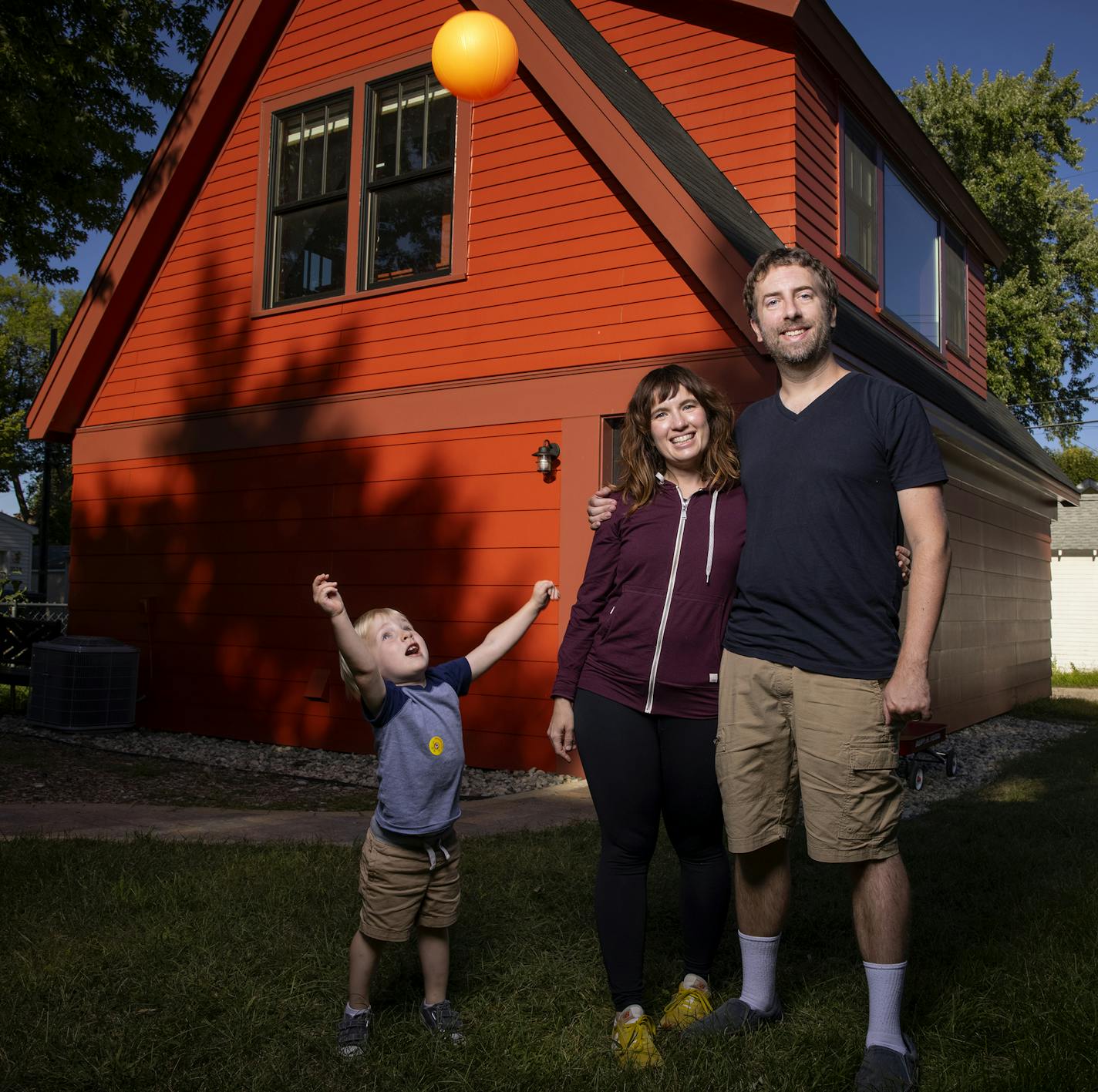 Stephanie Erickson Ross Pfund and son Quin Pfund, 2, photographed in front of their Accessory Dwelling Unit in Minneapolis. ] CARLOS GONZALEZ • cgonzalez@startribune.com – Minneapolis, MN – September 2, 2020, Home of the Month - bold little ADU on the alley expanded a young Minneapolis couple's living space