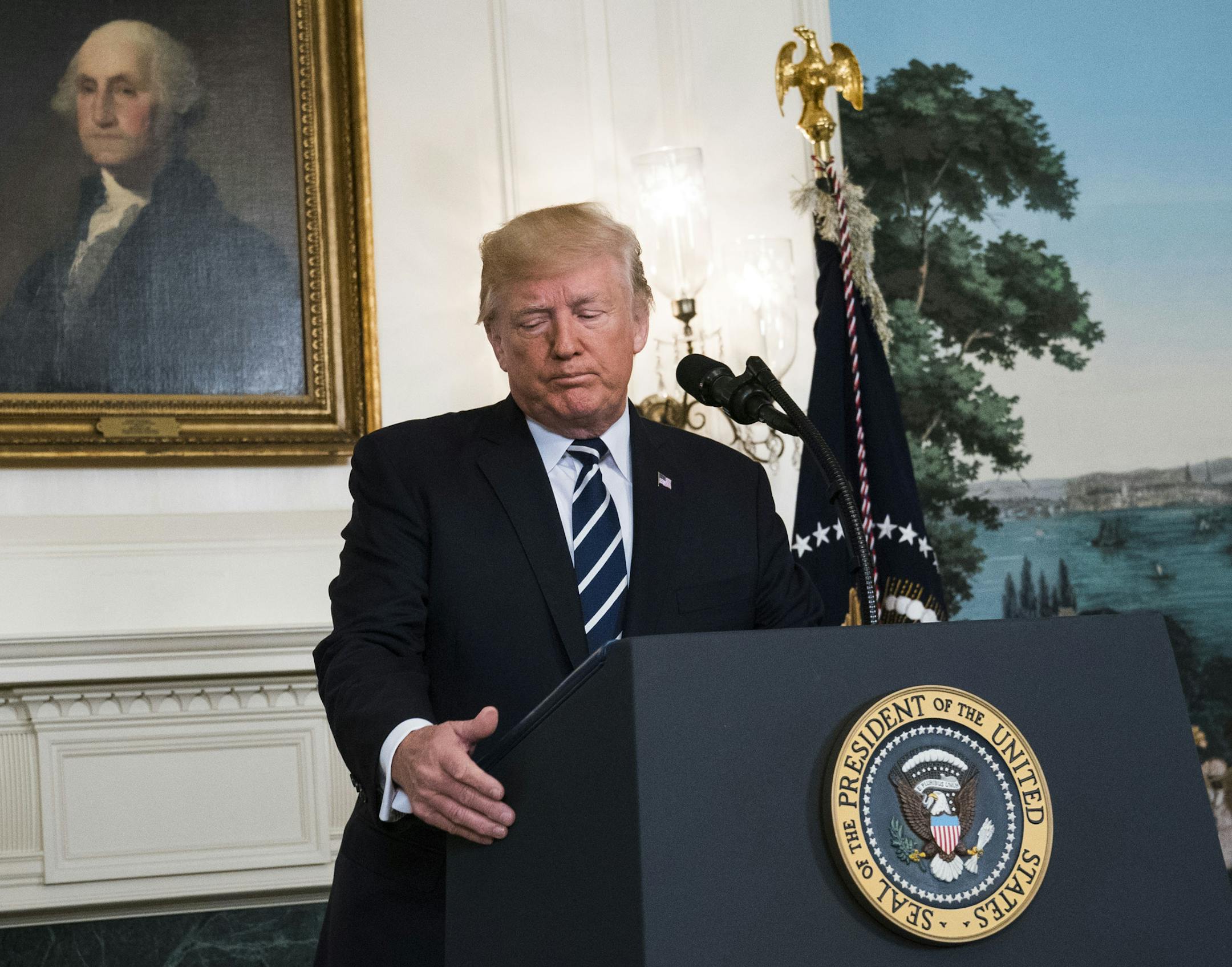 President Donald Trump concludes a statement about the mass shooting at a concert in Las Vegas the night before, in the Diplomatic Room of the White House in Washington, Oct. 2, 2017. Trump conveyed a message of unity Monday as he addressed the nation to share his sadness and offer prayers for those killed or injured in one of the deadliest mass shootings in U.S. history. (Doug Mills/The New York Times)