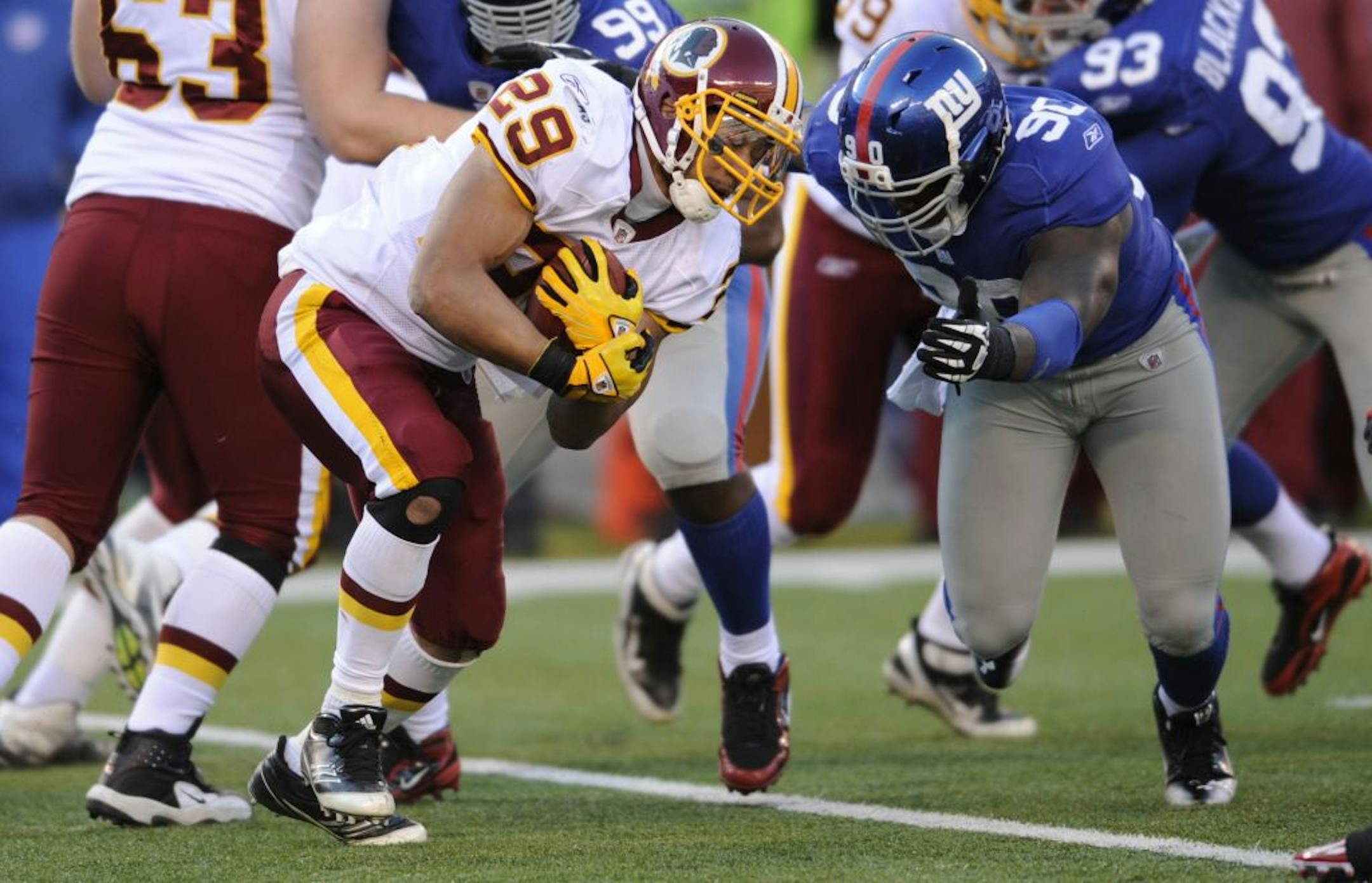 Washington Redskins' Roy Helu, left, is tackled by New York Giants' Jason Pierre-Paul during the second quarter of an NFL football game, Sunday, Dec. 18, 2011, in East Rutherford, N.J.