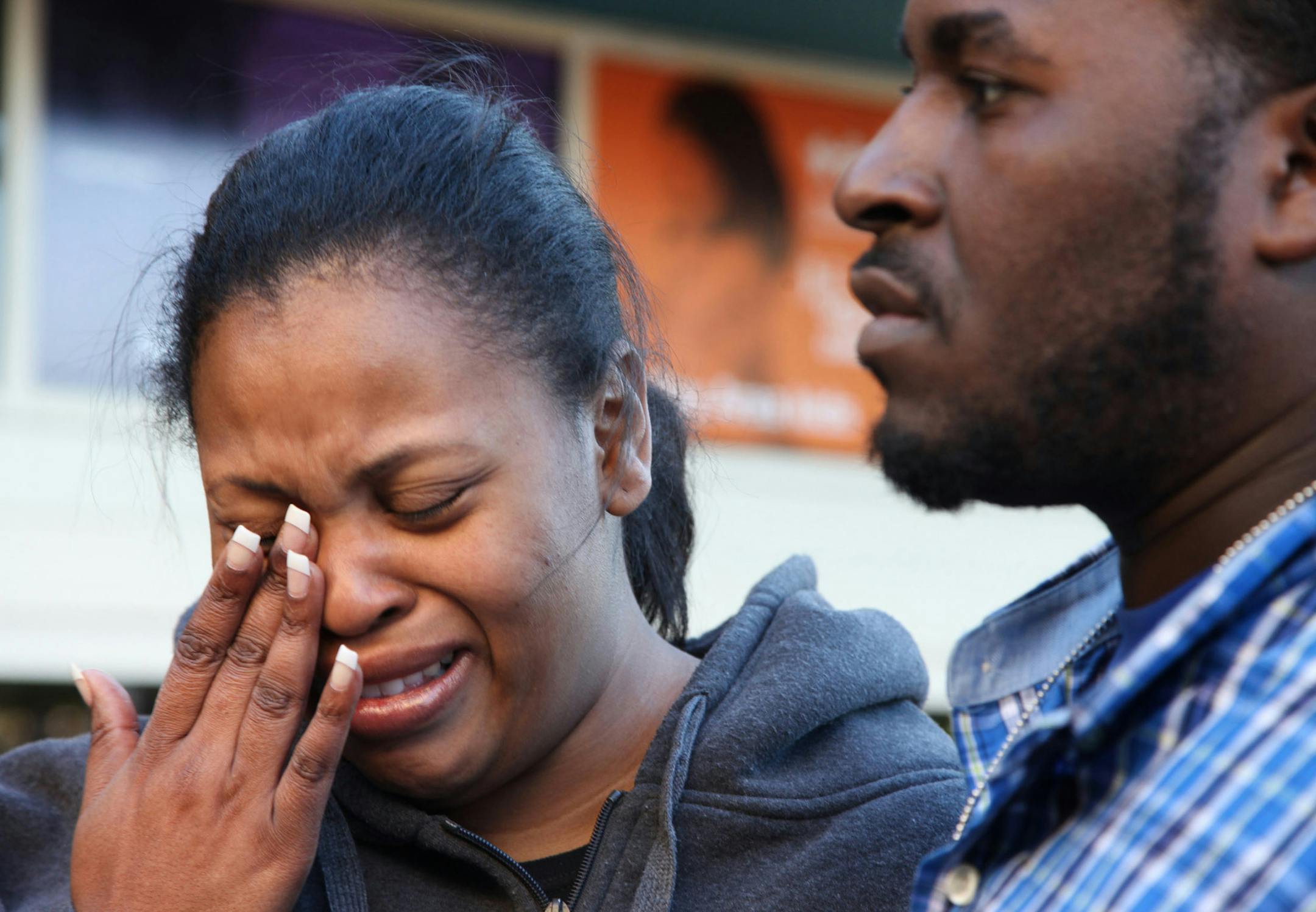 In this Dec. 16, 2013 photo, Nailah Winkfield, mother of Jahi McMath, wipes her face while speaking to reporters with her husband Martin Winkfield in front of Children's Hospital Oakland in Oakland, Calif. McMath remains on life support at Children's Hospital Oakland nearly a week after doctors declared her brain dead. (AP Photo/Bay Area News Group, Laura A. Oda) ORG XMIT: OTK_