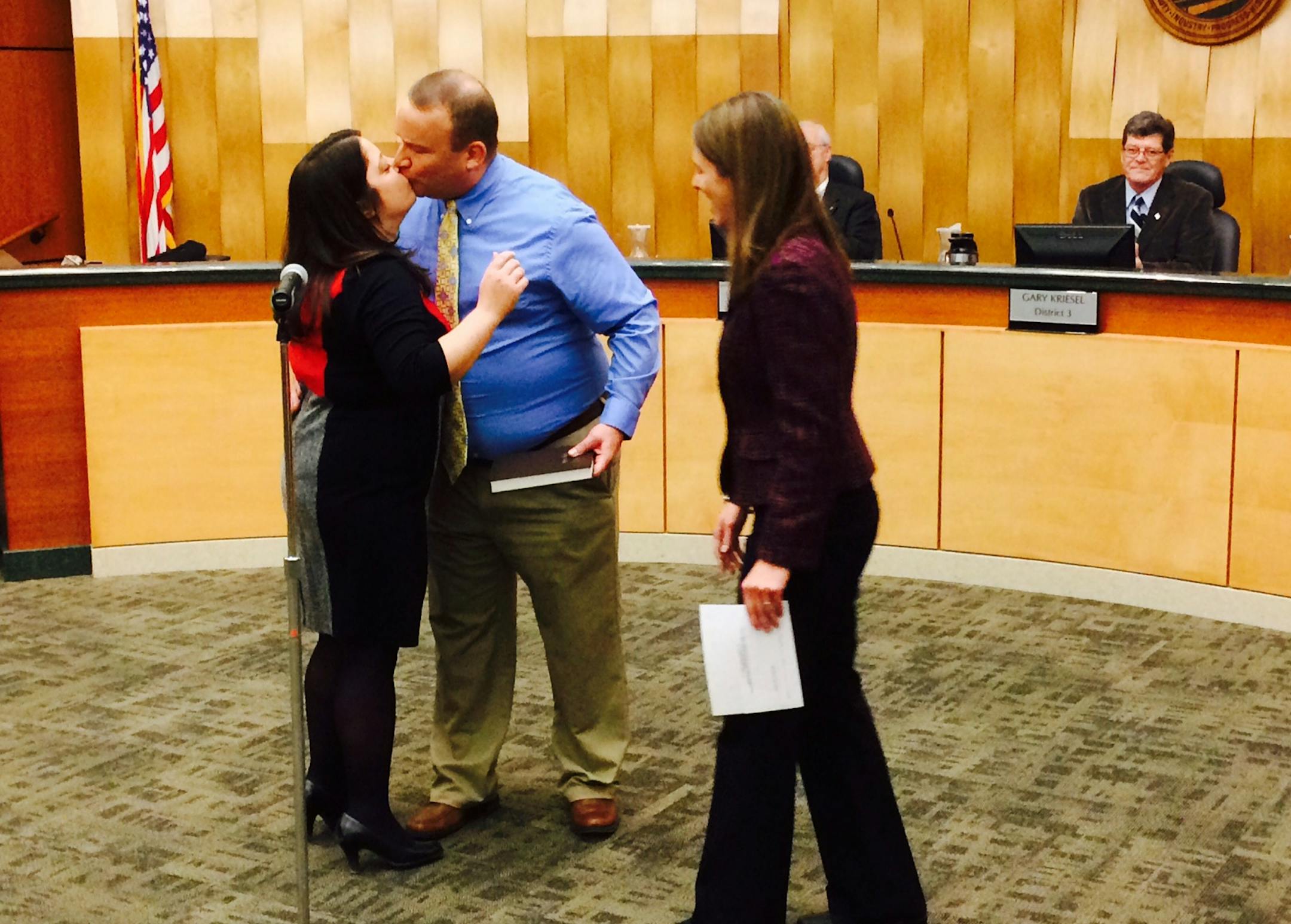 Karla Bigham's husband, John Stechmann, congratulates her after State Sen. Katie Sieben swore her into office at the Government Center in Stillwater last week. Bigham will represent District 4 on the County Board.