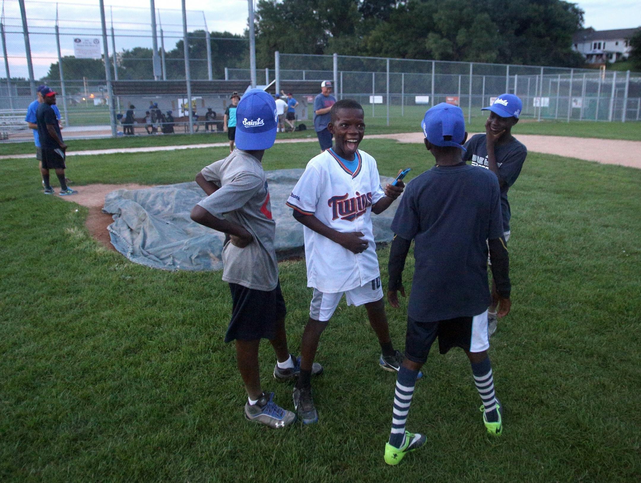 Fidele Akakpo, center, jokes with teammates after finishing an evening practice at Lakeview Terrace Field on Monday, August 1, 2016 in Robbinsdale.