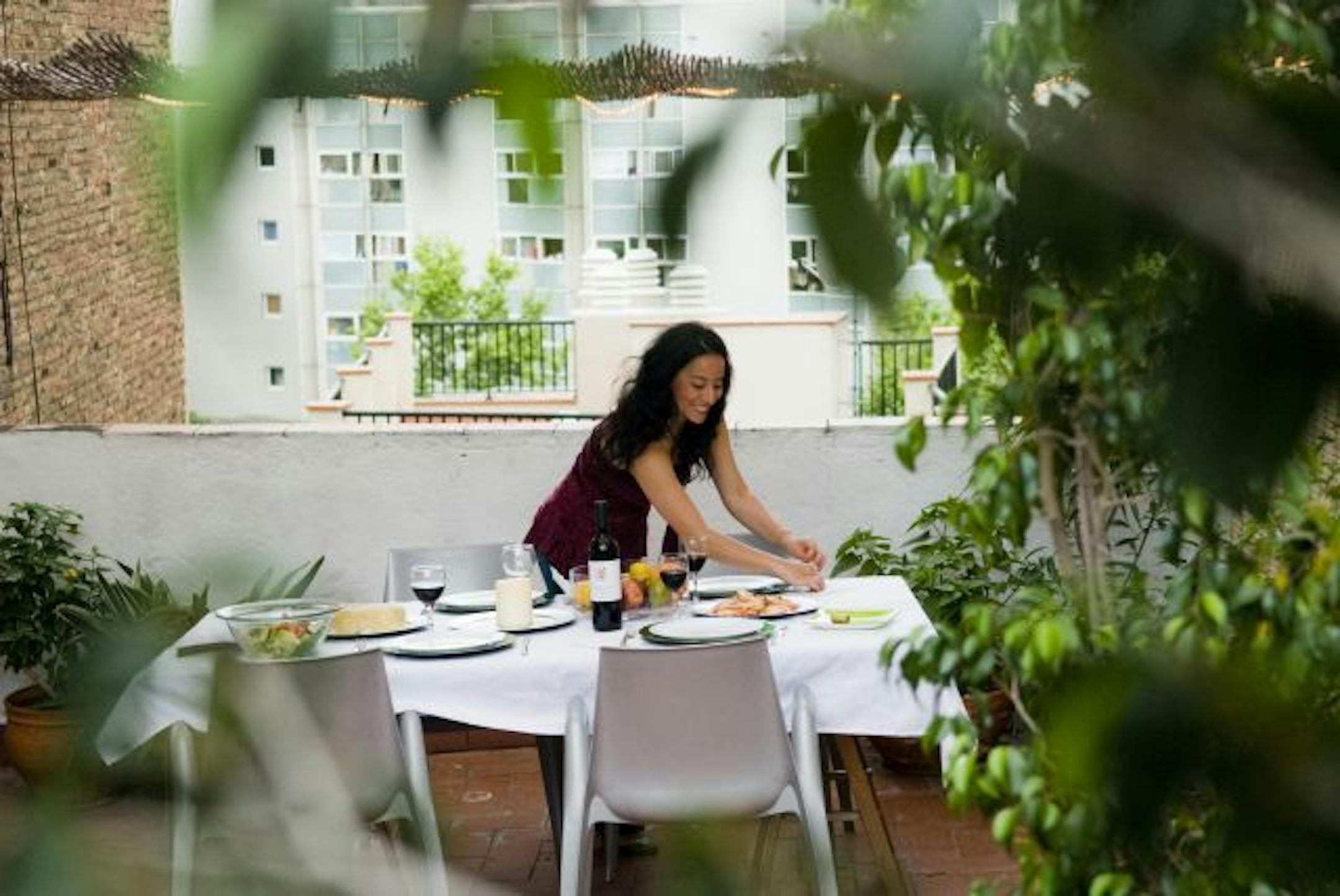 A guest sets the table at Arian Mostaedi's apartment in Barcelona, Spain, on June 21, 2010. Social bed and breakfast networks are a way to find, and offer, short-term stays all over the world.