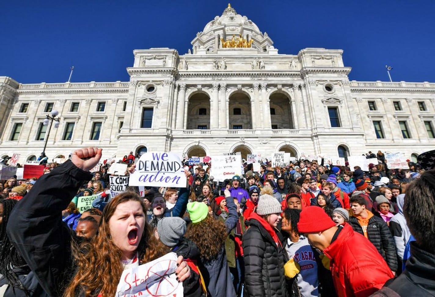 High school students walked out of their schools Wednesday and marched to the State Capitol to protest gun violence and pressure lawmakers to enact stricter gun control.