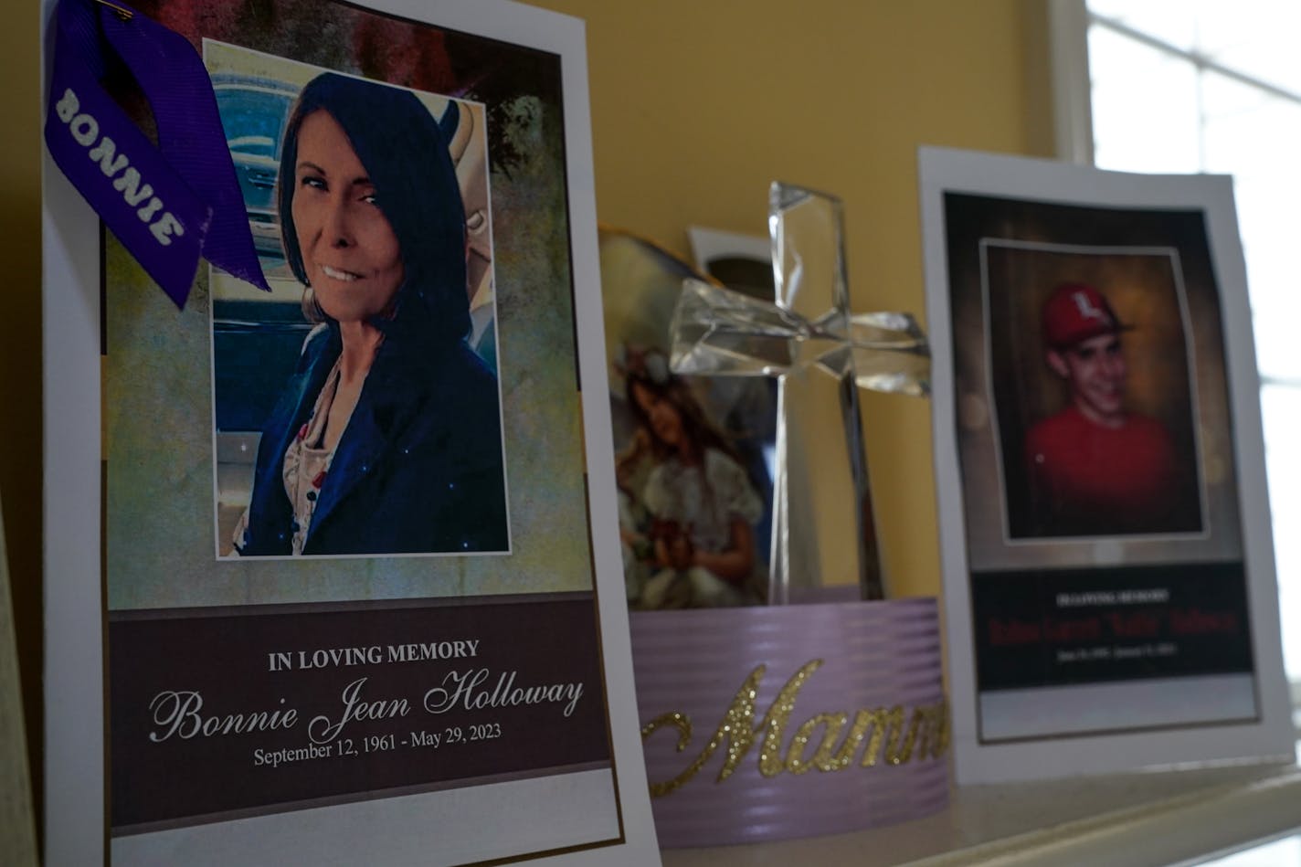 Two funeral programs on a mantel in Louisville attest to the toll of disease in one American family. Dalton Holloway, 30, died in January, after being diagnosed with lung cancer. His mother, Bonnie Jean Holloway, 61, died in May after years beset by chronic illnesses. MUST CREDIT: Washington Post photo by Jahi Chikwendiu