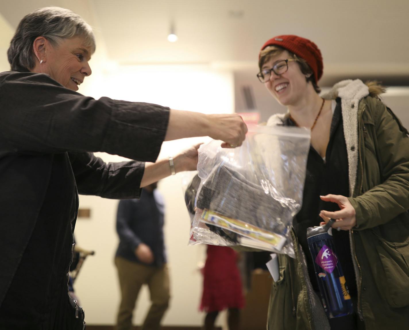 After the Bold Hope in the North event, Sue Perkins, a member of Westminster Presbyterian Church, handed out bags containing a hat, socks, hand sanitizer, a toothbrush and toothpaste to Allison Barrett. People attending the event were asked to take the bags and distribute them to people in need that they encountered. ] JEFF WHEELER ï jeff.wheeler@startribune.com The Downtown Congregations to End Homelessness hosted an interfaith gathering, tied to the upcoming Super Bowl, Bold Hope in the North,