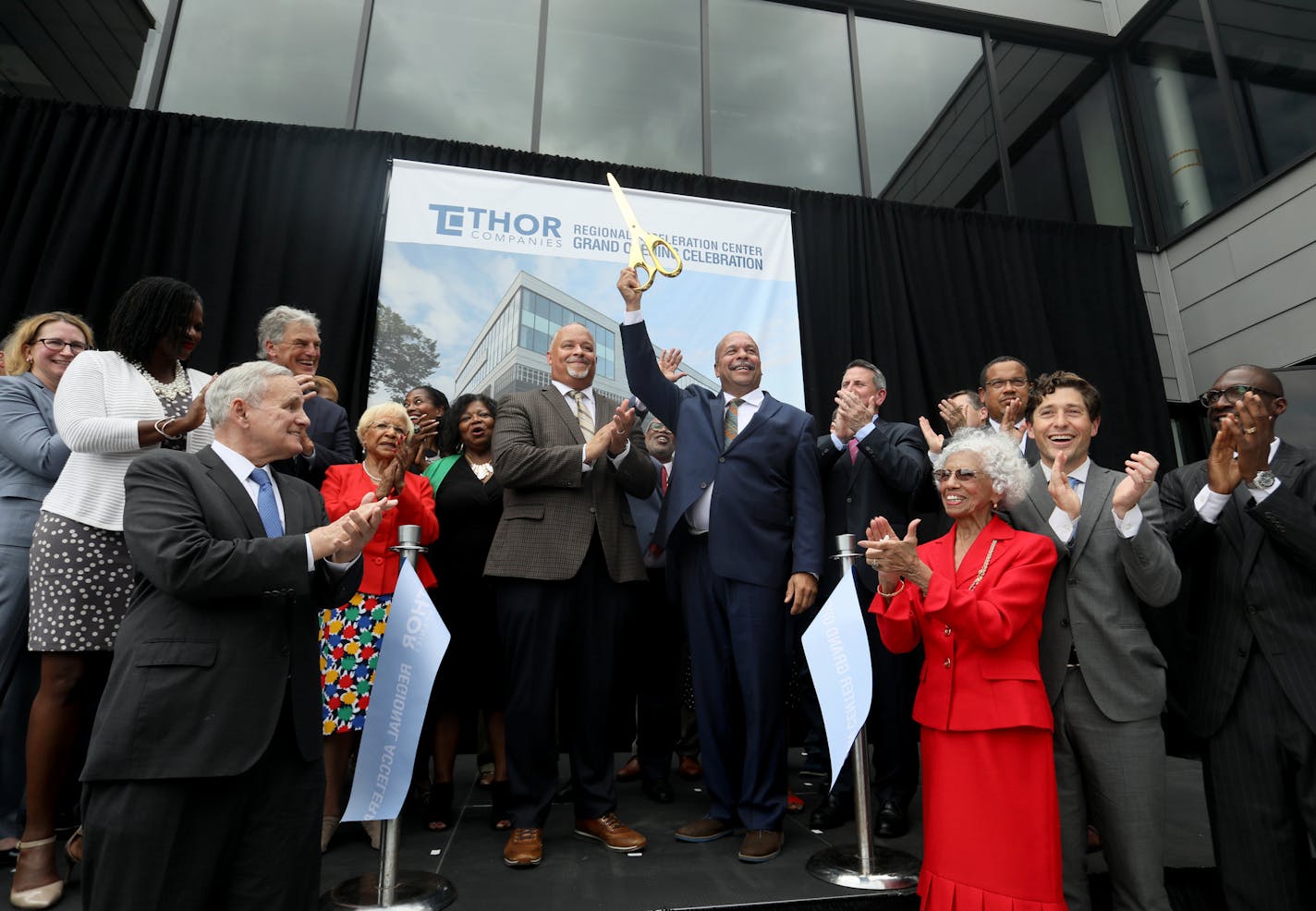 THOR Companies celebrated the opening of its new Regional Acceleration Center headquarters on the north side Friday, Sept. 14, 2018, in Minneapolis, MN. Here, Richard Copeland, THOR Companies chairman, middle right, and Ravi Norman, THOR Companies CEO, middle left, celebrate after cutting the ribbon at the opening.] DAVID JOLES &#xef; david.joles@startribune.com THOR Cos. is celebrating the opening of its new headquarters in the North Side with a lot of guests, including Gov. Dayton, Keith Ellis