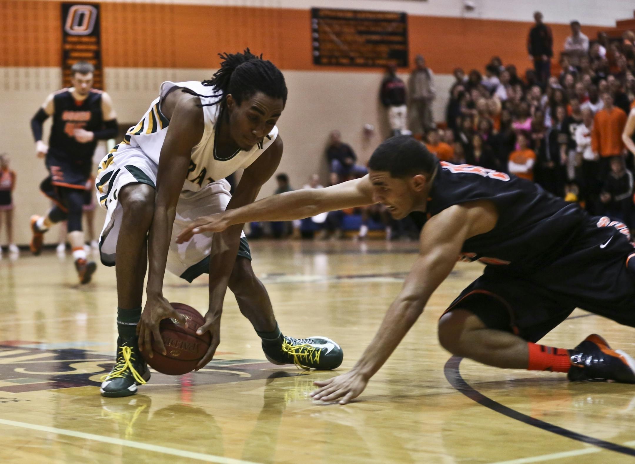 Park Center's Joshua Matthews and Osseo's Bridgeport Tusler struggled for the ball.