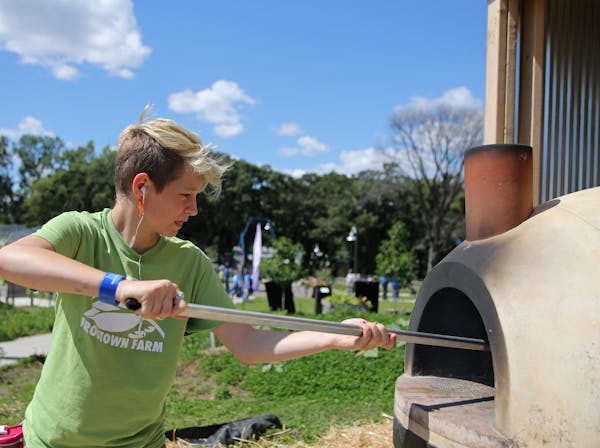 Elliot Cooper cooked pizzas in the wood fire grill at Frogtown Farms. ] Shari L. Gross &#xef; shari.gross@startribune.com The Minnesota Superbowl Comm