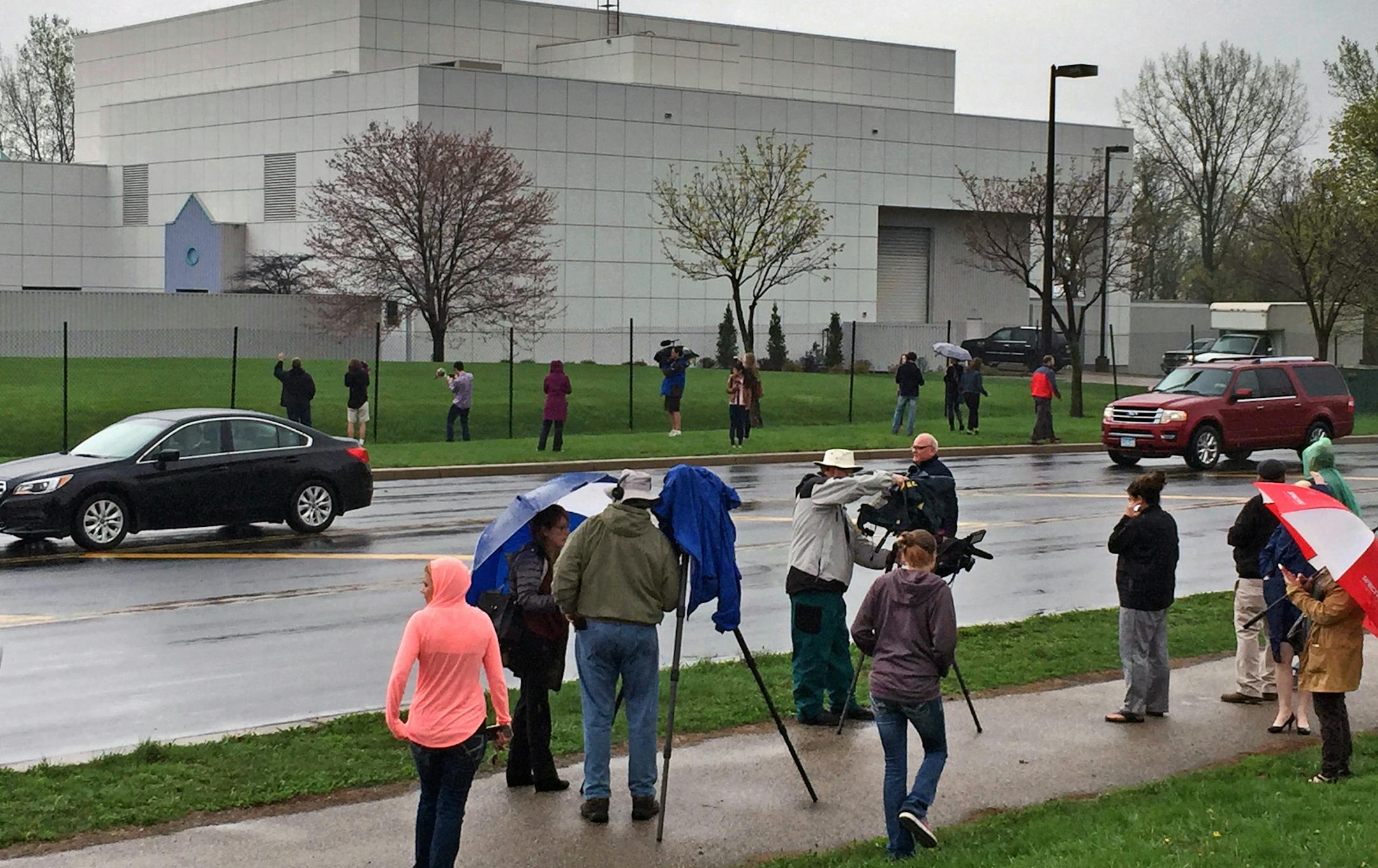 FILE - In this April 21, 2016 file photo, people stand outside entertainer Prince's Paisley Park compound in Chanhassen, Minn. Court filings in Prince's estate show that a special administrator, and likely Prince's siblings, are eager to explore the money-making potential of making a tourist attraction out of his Paisley Park home and studio complex. (Jim Gehrz/Star Tribune via AP, File) MANDATORY CREDIT; ST. PAUL PIONEER PRESS OUT; MAGS OUT; TWIN CITIES LOCAL TELEVISION OUT TV is soft out