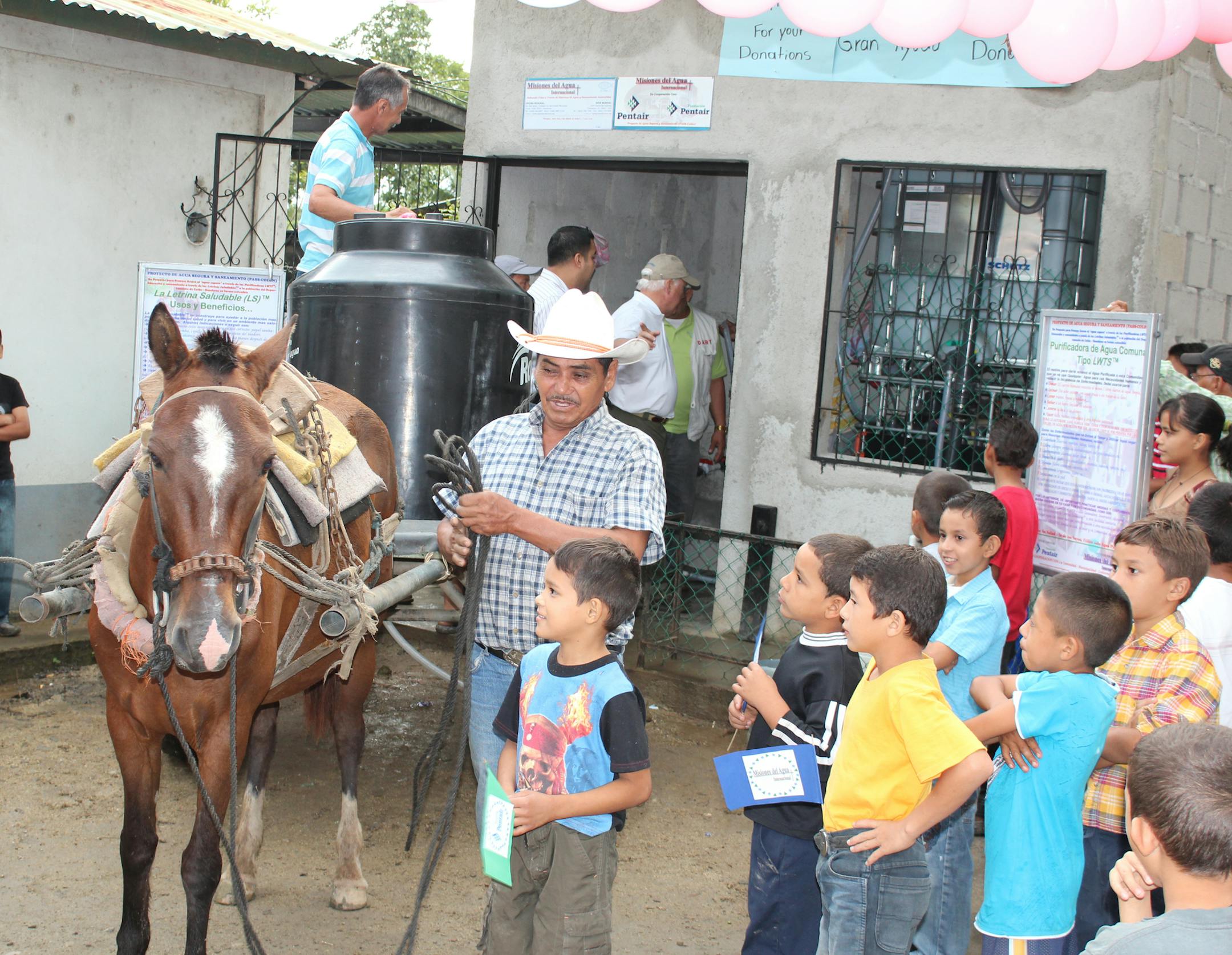 Pentair and Water Mission officials worked with citizens in Colón, Honduras, to ensure the new water filtration system will be maintained by locals. Here, a Colón man filled a cistern for his village with clean water from the Pentair system, which has helped drop the waterborne disease rate there by 80 percent.