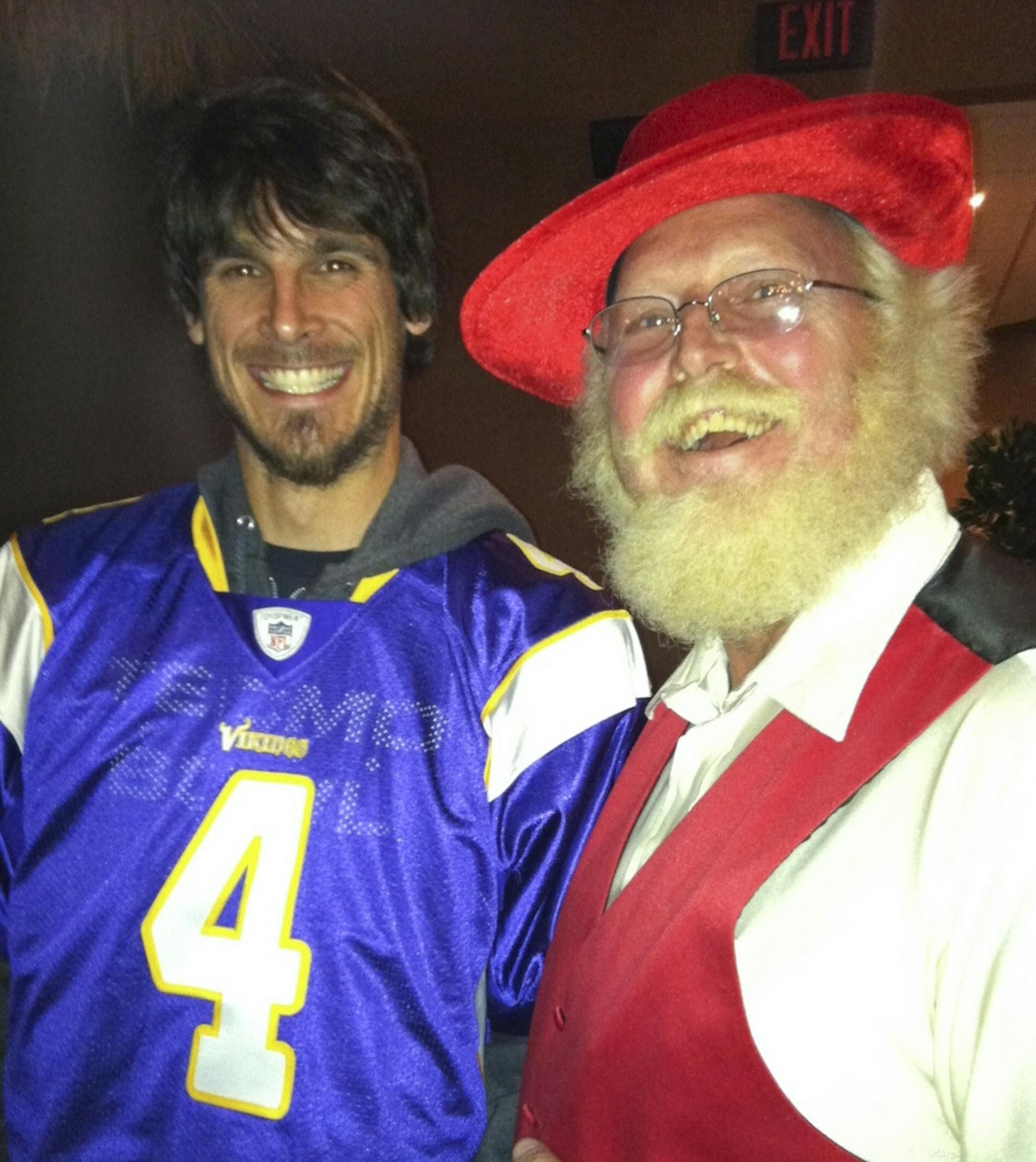 Chris Kluwe, who participated in a social media-themed ticket giveaway Wednesday night, posed with Santa lookalike Rob Mathewson.