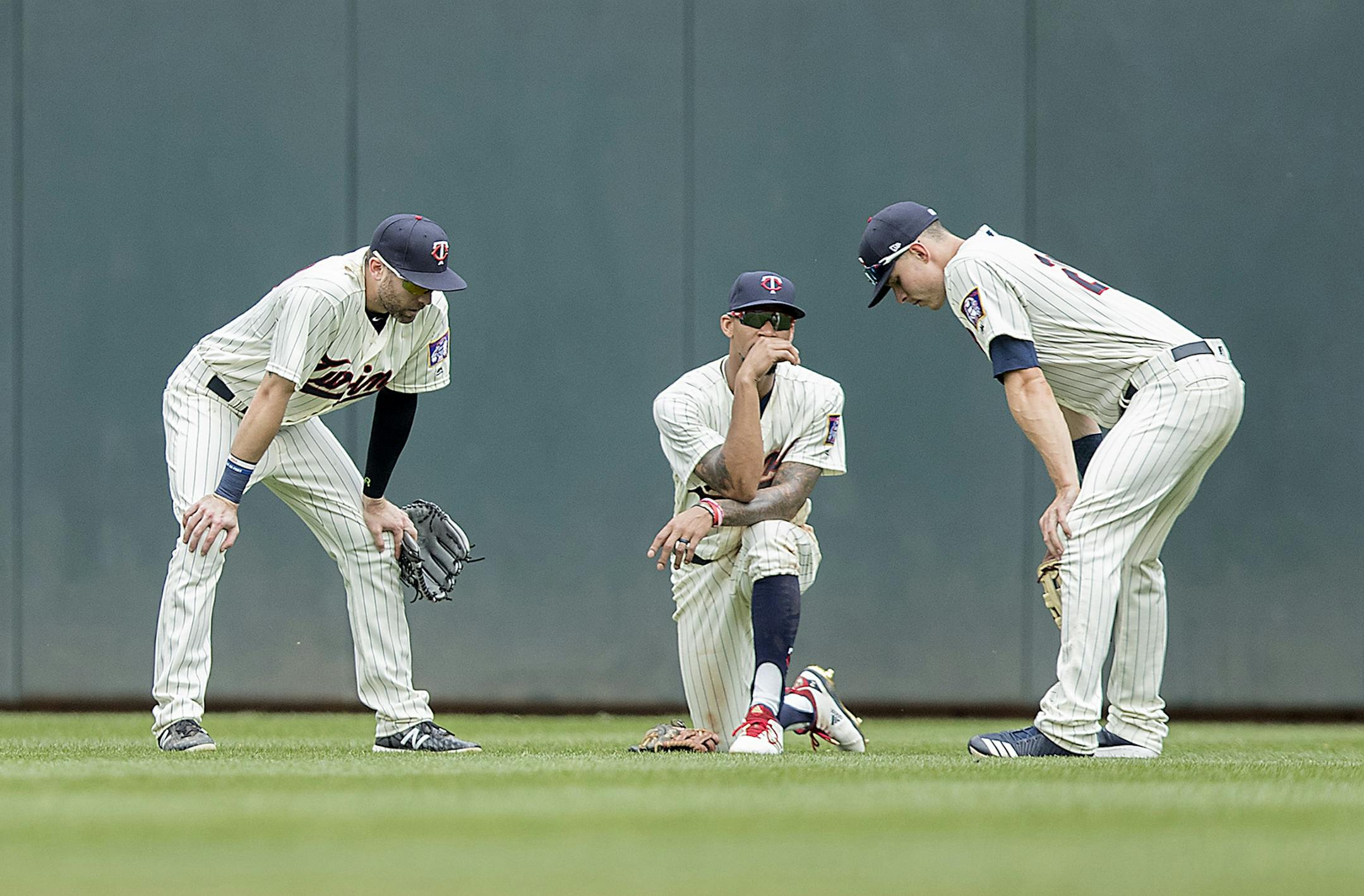 Minnesota Twins center fielder Jake Cave, left, Byron Buxton, center, and right fielder Max Kepler chat during a pitching change during the top of the eighth inning as the Twins took on the Tigers at Target Field, Wednesday, May 23, 2018 in Minneapolis, Minn. The Tigers won, 4-1. (Elizabeth Flores/Minneapolis Star Tribune/TNS) ORG XMIT: 1231881
