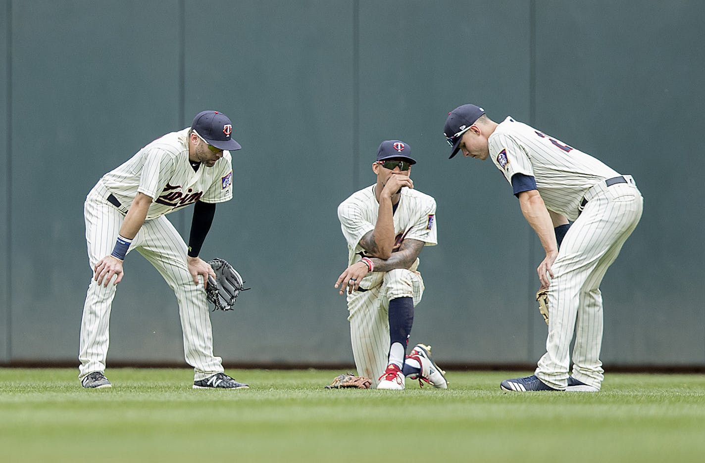 Minnesota Twins center fielder Jake Cave, left, Byron Buxton, center, and right fielder Max Kepler chat during a pitching change during the top of the eighth inning as the Twins took on the Tigers at Target Field, Wednesday, May 23, 2018 in Minneapolis, Minn. The Tigers won, 4-1. (Elizabeth Flores/Minneapolis Star Tribune/TNS) ORG XMIT: 1231881