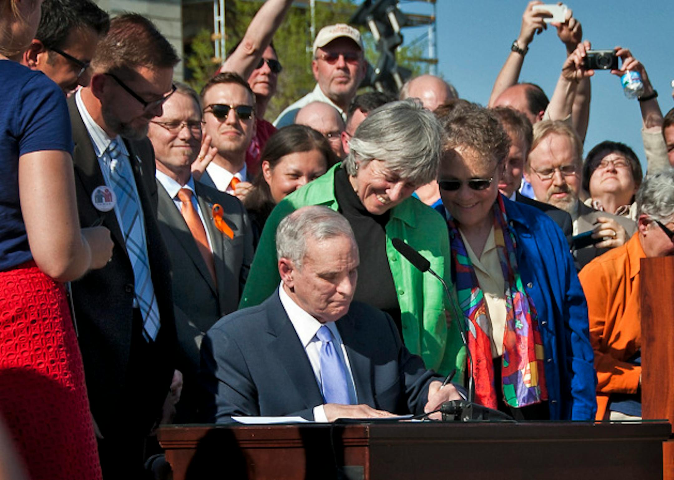Governor Mark Dayton signed the marriage bill into law Tuesday, May 14, 2013  in front he the Capitol.  With him were bill authors  Senator Scott Dibble with husband Mark Leyva and Rep. Karen Clark with her partner Jacqueline Zita and all the legislators who voted yes.    ]   GLEN STUBBE * gstubbe@startribune.com