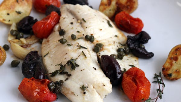 Mild-flavored tilapia is a forgiving ingredient and goes well with kalamata olives, tomatoes and fingerling potatoes. (Jessica J. Trevino/Detroit Free