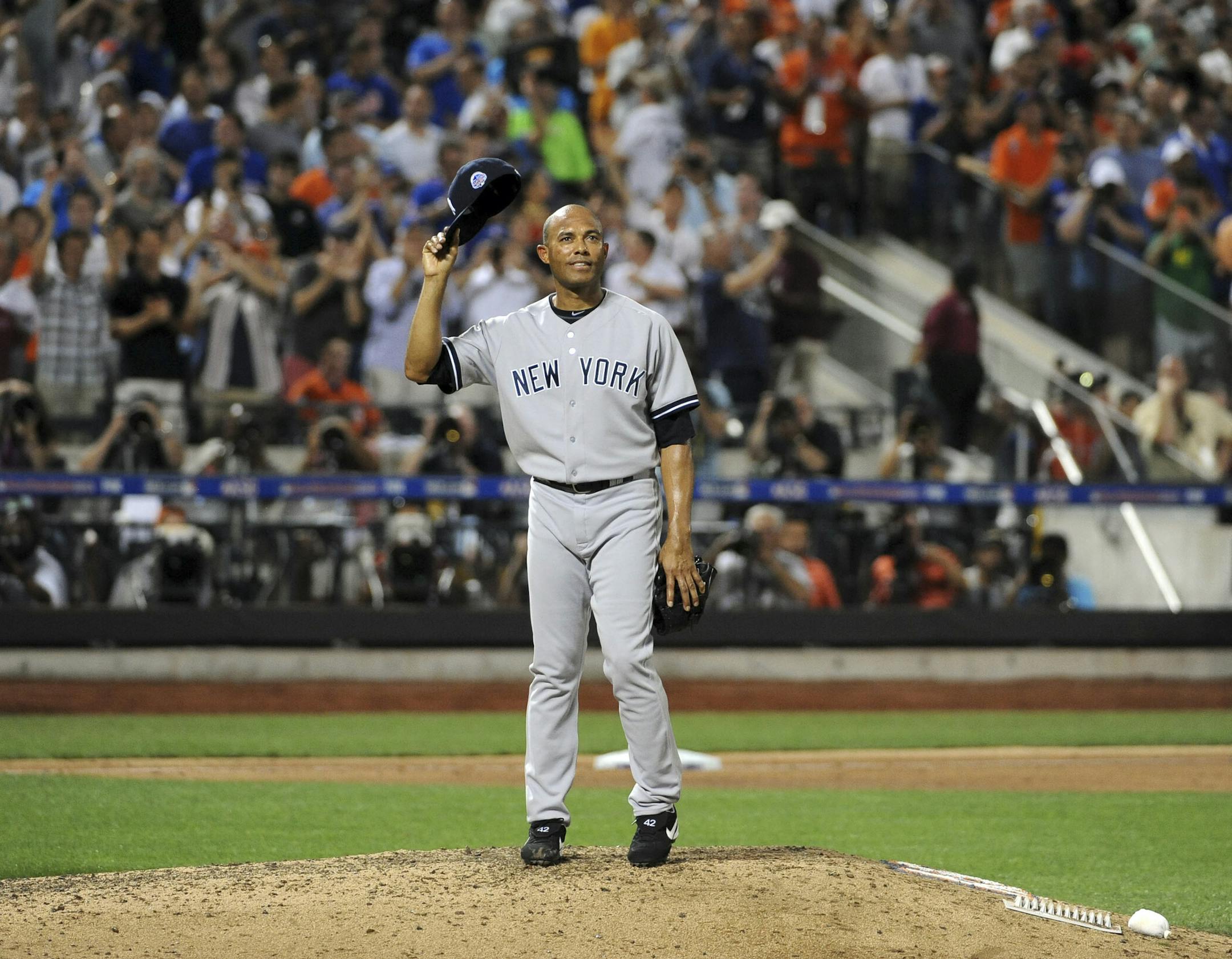 New York Yankees pitcher and American League All-Star Mariano Rivera tips his cap to the crowd in the eighth inning of the MLB All-Star Game at Citi Field in New York, July 16, 2013. (Barton Silverman/The New York Times)