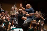 Librettist Marc Bamuthi Joseph, with conductor Bill Eddins, practiced during the rehearsal of "brea(d)th" with the Minnesota Orchestra Monday ,March,2