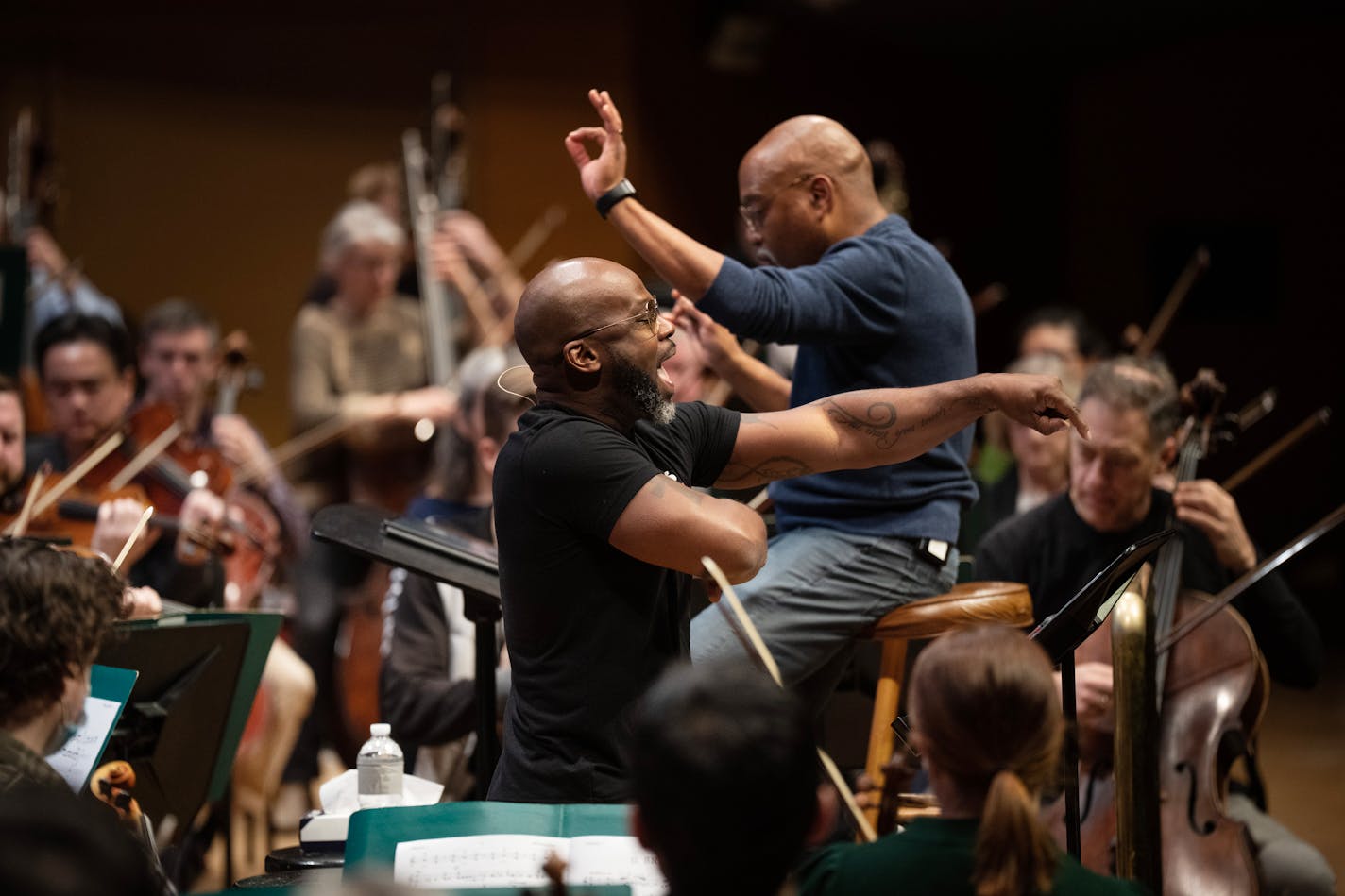 Librettist Marc Bamuthi Joseph, with conductor Bill Eddins, practiced during the rehearsal of "brea(d)th" with the Minnesota Orchestra Monday ,March,20,2023 in Minneapolis, Minn.] JERRY HOLT • jerry.holt@startribune.come