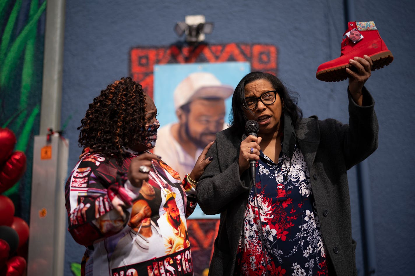 Del Shea Perry presented Kimberly Handy-Jones (left) with a pair of red Timberland boots, her son Cordale Handy's favorite brand, to honor her signature rallying cry of "Boots on the ground!" Perry's son, Hardel Sherrell, died in police custody in the Beltrami County jail in 2018. ] JEFF WHEELER • jeff.wheeler@startribune.com