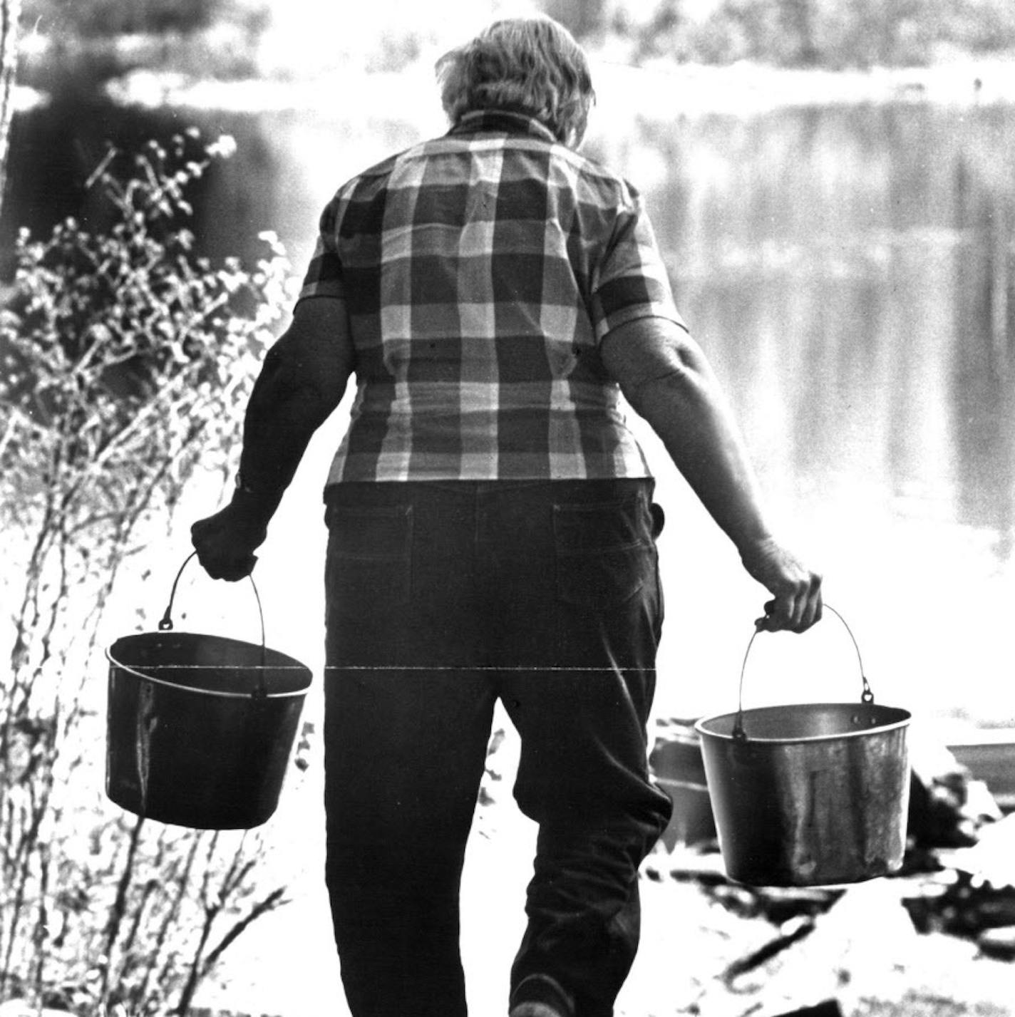 September 18, 1980 Dorothy Molter gets gets drinking water from lake. She has lived alone on three tiny islands in Knife Lake in the northern Minnesota wilderness for 50 years. She has no electricity and is three hours by boat from the closest road and 60 miles from the closest grocery. Dorothy Molter is 73. To do her laundry, she heats water in a wood stove and uses a scrub board. Her refrigerator is an ice house filled with chunks of ice that she cuts from the lake with a chain saw. For heatin