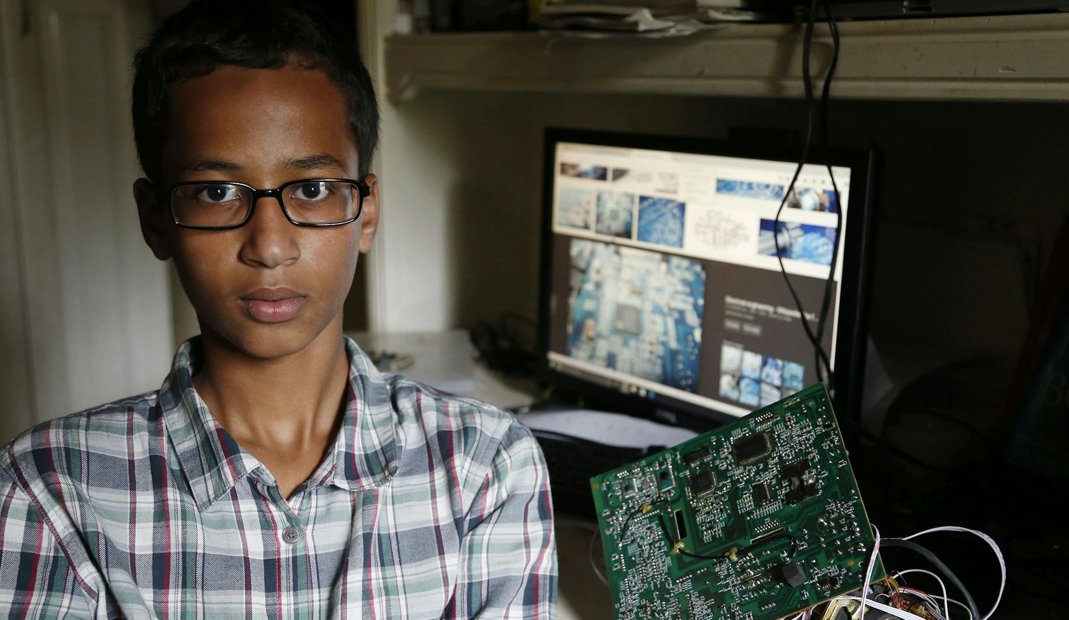 Irving MacArthur High School student Ahmed Mohamed, 14, poses for a photo at his home in Irving, Texas on Tuesday, Sept. 15, 2015. Mohamed was arrested and interrogated by Irving Police officers on Monday after bringing a homemade clock to school. Police don't believe the device is dangerous, but say it could be mistaken for a fake explosive. He was suspended from school for three days, but he has not been charged.