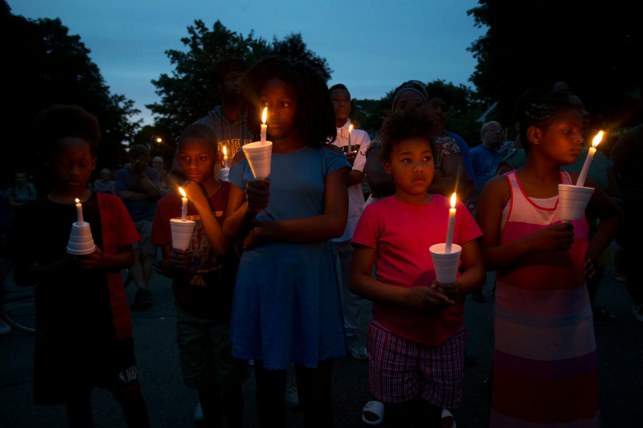 (From left) Christian Young, Damarion Sims, Emahnie Griffin, Sonia Young and Nieyhema Griffin hold candles as dusk falls on the vigil Sunday night . ] ALEX KORMANN � alex.kormann@startribune.com Dozens of local community members, family of Thurman Belvins and activists gathered at the corner of 48th street and Camden Ave on Sunday evening for a candle lit vigil to remember the life of Belvins who died Saturday. Belvins was shot by police starting on that same corner Saturday afternoon. Community