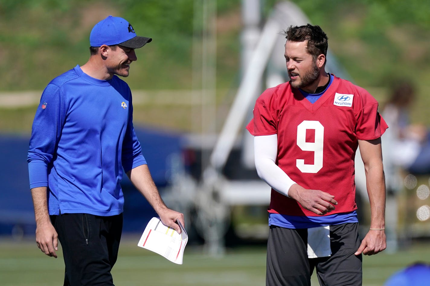 Los Angeles Rams offensive coordinator Kevin O'Connell, left, talks with quarterback Matthew Stafford during practice for an NFL Super Bowl football game Wednesday, Feb. 9, 2022, in Thousand Oaks, Calif. The Rams are scheduled to play the Cincinnati Bengals in the Super Bowl on Sunday. (AP Photo/Mark J. Terrill)