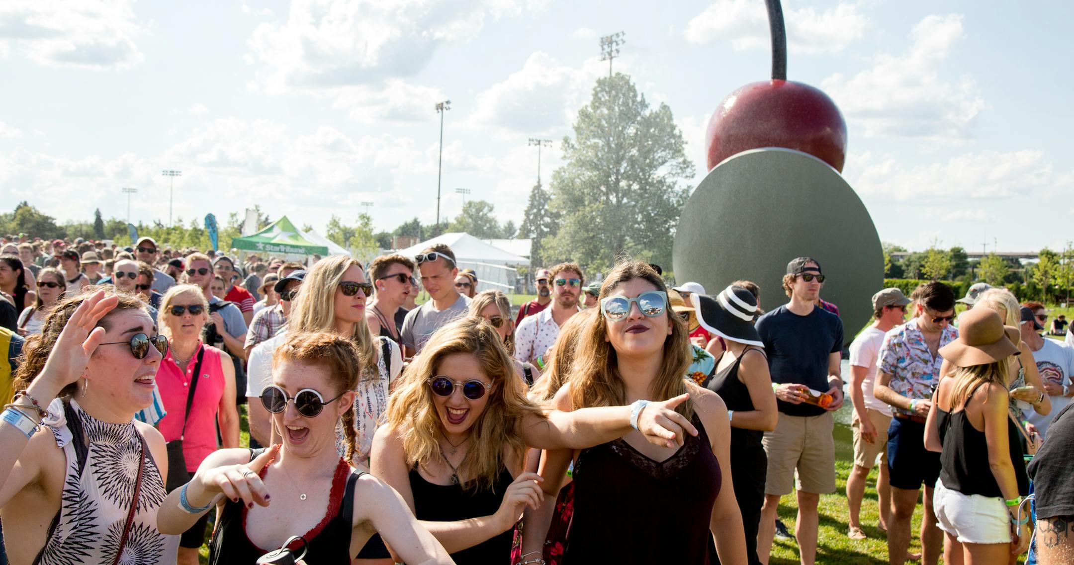 Emma Symanski, Isabelle Jones, Maia Mingelgrin and May Keret dance while Dwynell Roland performs during Rock the Garden outside Walker Art Center in Minneapolis on Saturday. ] COURTNEY PEDROZA • courtney.pedroza@startribune.com; Rock the Garden 2017 headlined by Bon Iver and Prince's Revolution outside Walker Art Center; Minneapolis; July 22, 2017