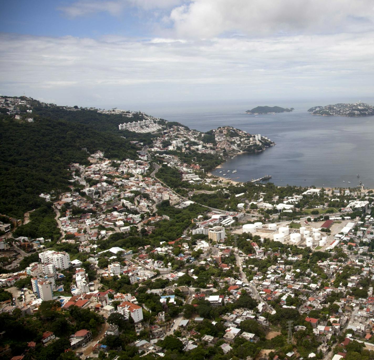 FILE - This Sept. 20, 2013 file photo shows an aerial view of the Pacific resort city of Acapulco, Mexico. The Mexican coastal city pulled a pair of controversial video ads Thursday, Aug. 6, 2020, touting the faded resort's reputation as an "anything goes" tourism destination because they weren't appropriate during the new coronavirus pandemic. (AP Photo/Eduardo Verdugo, File)