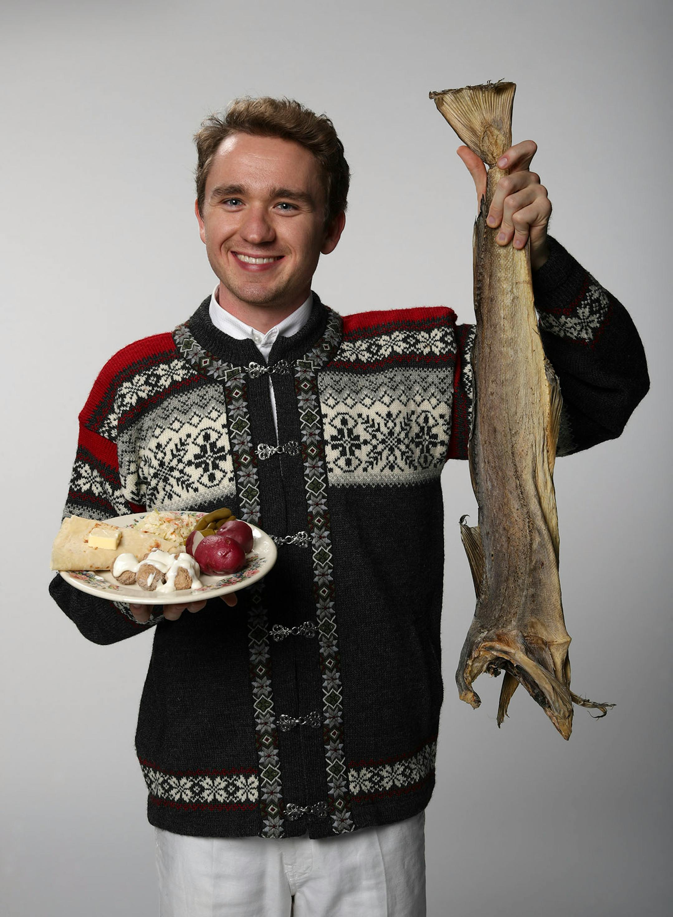 Nels Thompson with a dried cod, the basis of many a Scandinavian holiday meal. ] JEFF WHEELER ï jeff.wheeler@startribune.com Nels Thompson took over planning the traditional Scandinavian holiday meal at his church with the intent of making it appeal to twentysomethings like himself. He was photographed with dried cod in the StarTribune studio on Thursday afternoon, November 3, 2016.