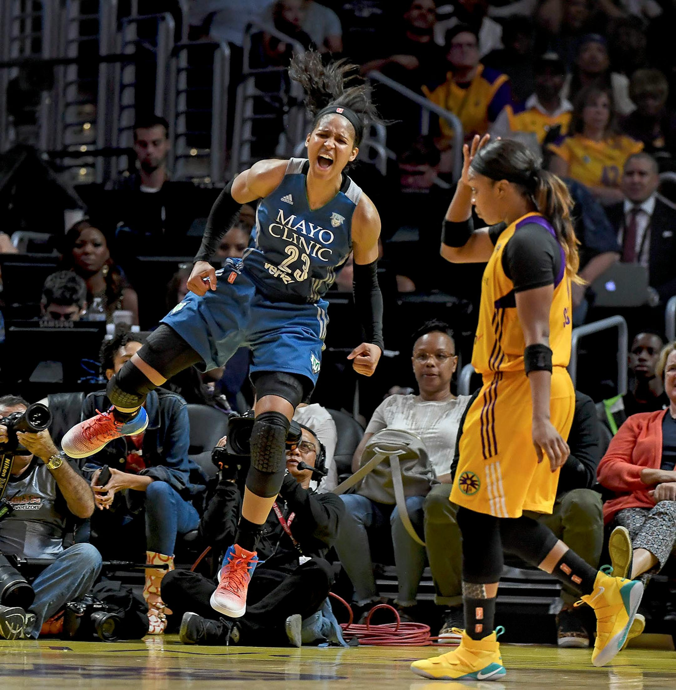 Minnesota Lynx forward Maya Moore (23) celebrated after scoring a layup while being fouled by Los Angeles Sparks forward Candace Parker (3) for an and-one opportunity in the fourth quarter Sunday.