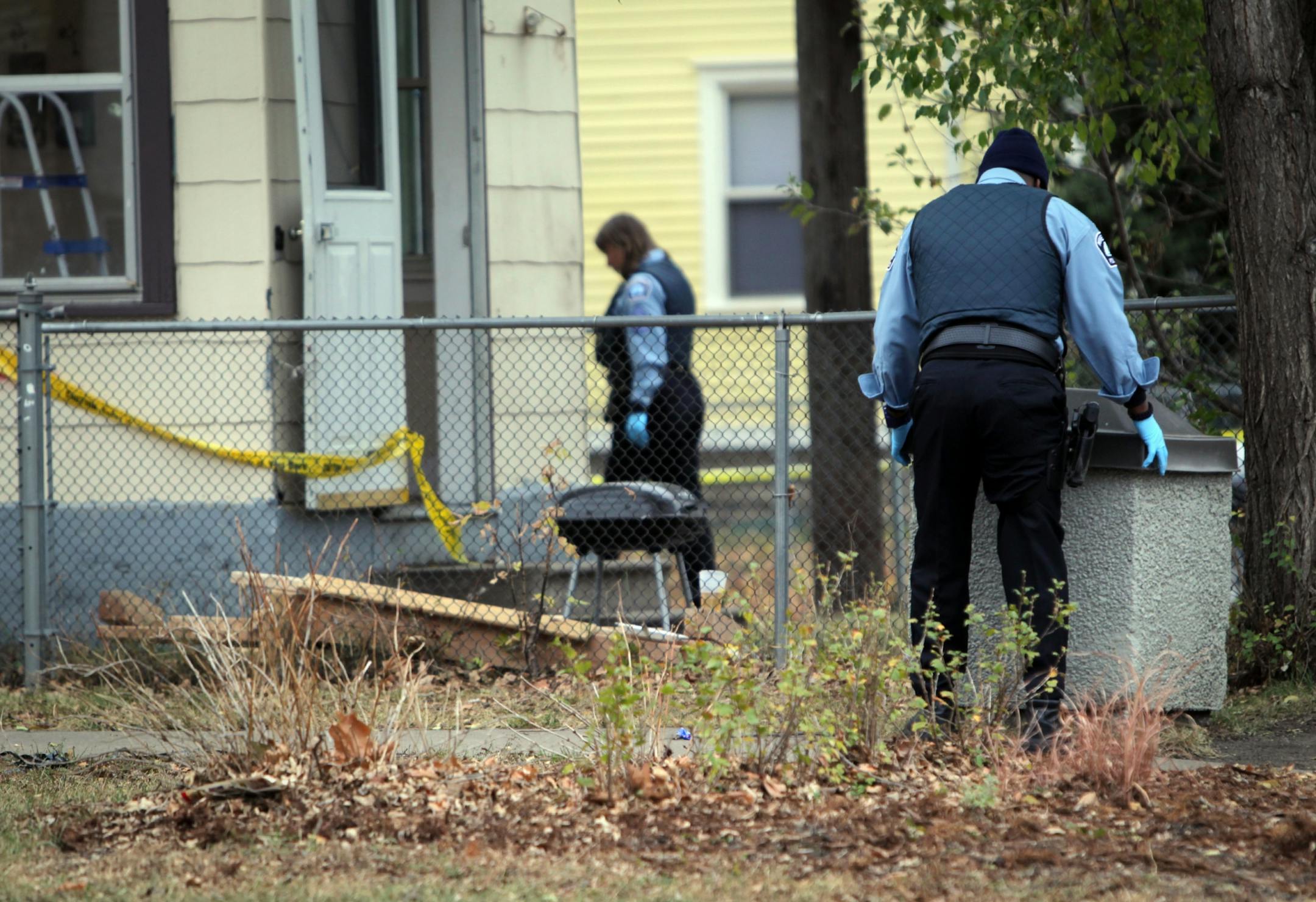 Police searched for evidence near the building where Hernandez was shot early Sunday.