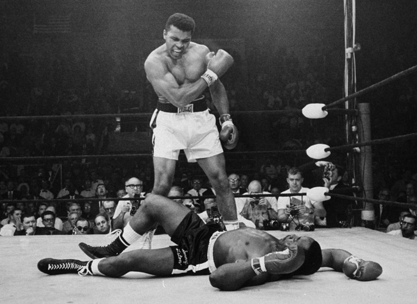 FILE - In this May 25, 1965, file photo, heavyweight champion Muhammad Ali stands over fallen challenger Sonny Liston, shouting and gesturing shortly after dropping Liston with a short hard right to the jaw in the first round of their title fight in Lewiston, Maine. The bout produced one of the strangest finishes in boxing history as well as one of sports� most iconic moments.