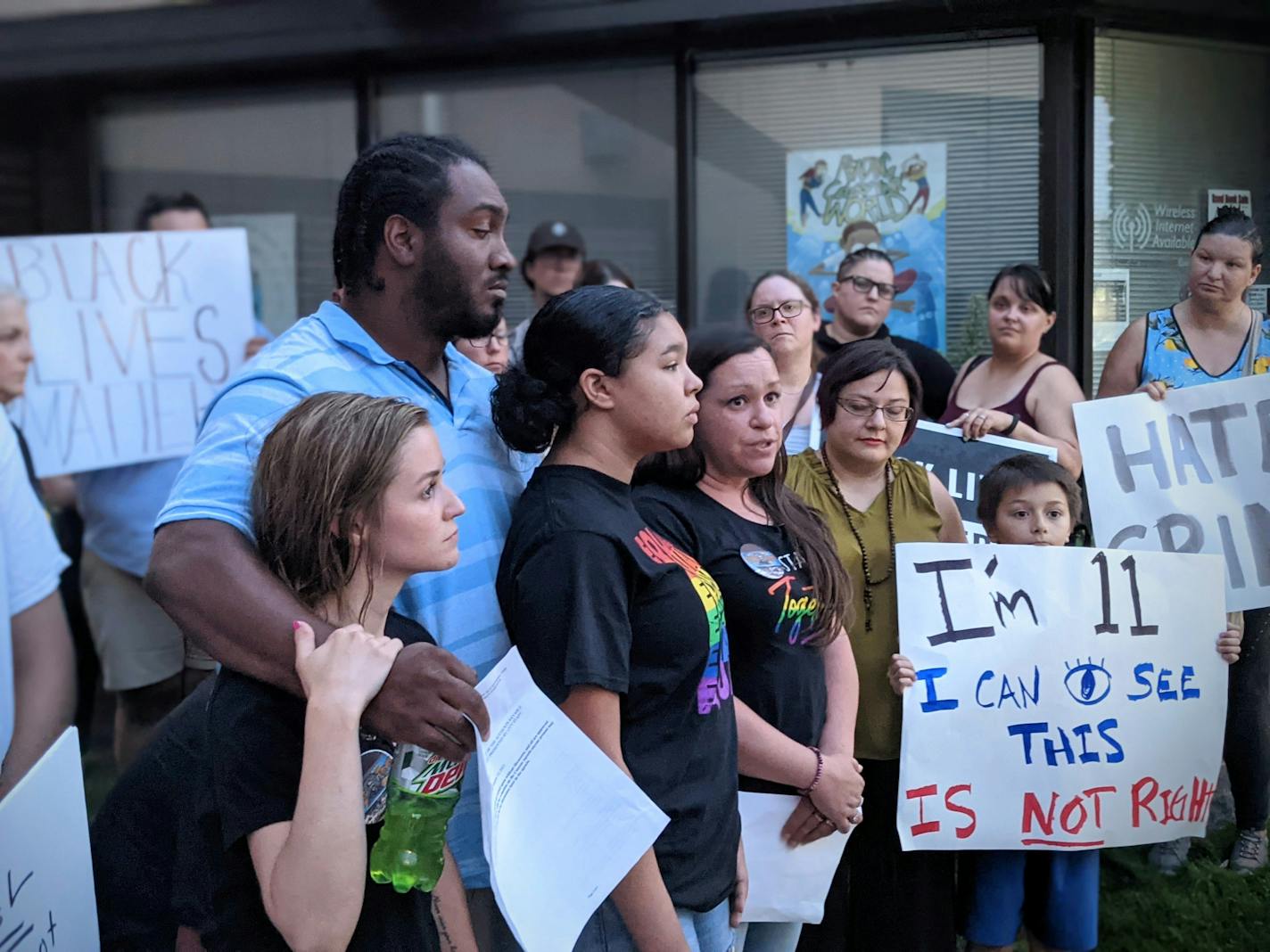 Andrea Robinson, center, answers questions following the Cold Spring City Council meeting Tuesday, July 27, 2021. Her family — including daughter Jackie Umerski, husband Phil and daughter Olivia Williams, pictured from left — have endured harassment while living in the community. (Credit: Jenny Berg)