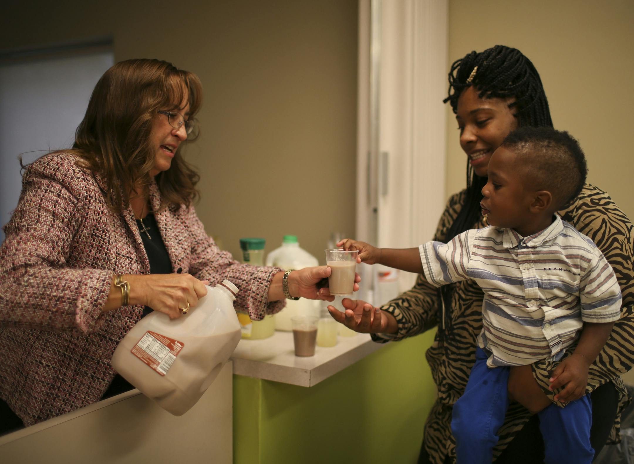The successful Minneapolis non-profit Jeremiah Program that has helped thousands of women move from poverty to self sufficiency, is going national. In the dining room of the Jeremiah Program's Minneapolis residence, Tiffany Hodges held her son, Courtney, as he reached for a second glass of milk that was being poured by Carla Pedersen, who was volunteering Tuesday evening, September 17, 2013. ] JEFF WHEELER ‚Ä¢ jeff.wheeler@startribune.com
