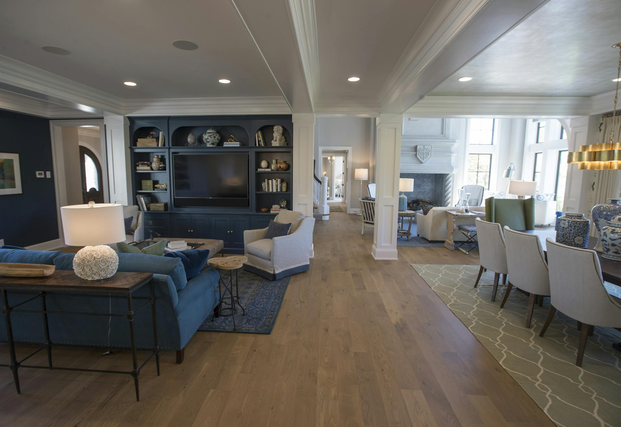 The home has an open floor plan. The sitting room, left, and dining room, right, were designed by Keri Olson and Kimberly Herrick.