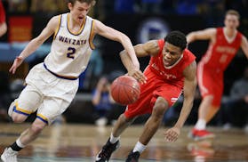 Ethan Igbanugo right of Lakeville North stole the ball from Jacob Beeninga of Wayzata during quarterfinal class 4A basketball action at Target Center 