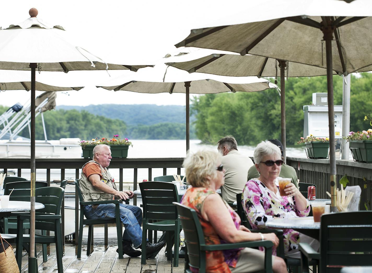 Diners enjoy lunch on the deck at Marine Landing b.o.t.m. in Marine on St. Croix June 26, 2014. Usually 8 to 10 feet above the river, on this day the deck was flush with the water level. (Courtney Perry/Special to the Star Tribune)