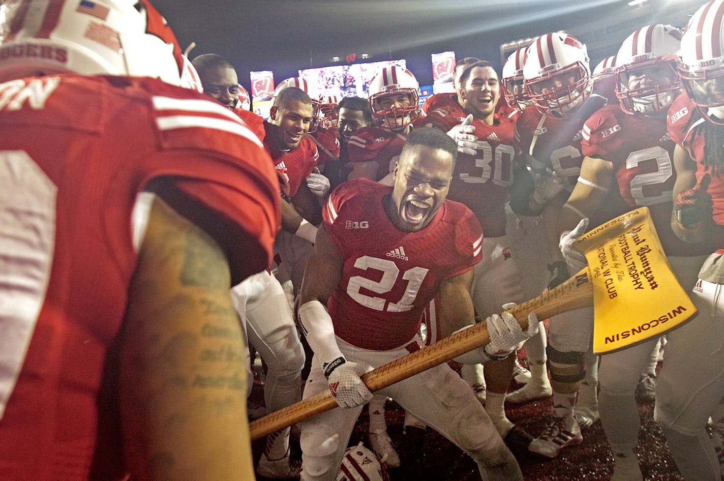 Wisconsin's cornerback Peniel Jean (21) took the post game axe to the visiting post after they defeated the Minnesota Gophers 34-24 at Camp Randall Stadium, Saturday, November 29, 2014 in Madison, Wis. ] (ELIZABETH FLORES/STAR TRIBUNE) ELIZABETH FLORES &#xef; eflores@startribune.com ORG XMIT: MIN1411291825530470 ORG XMIT: MIN1411291830410474