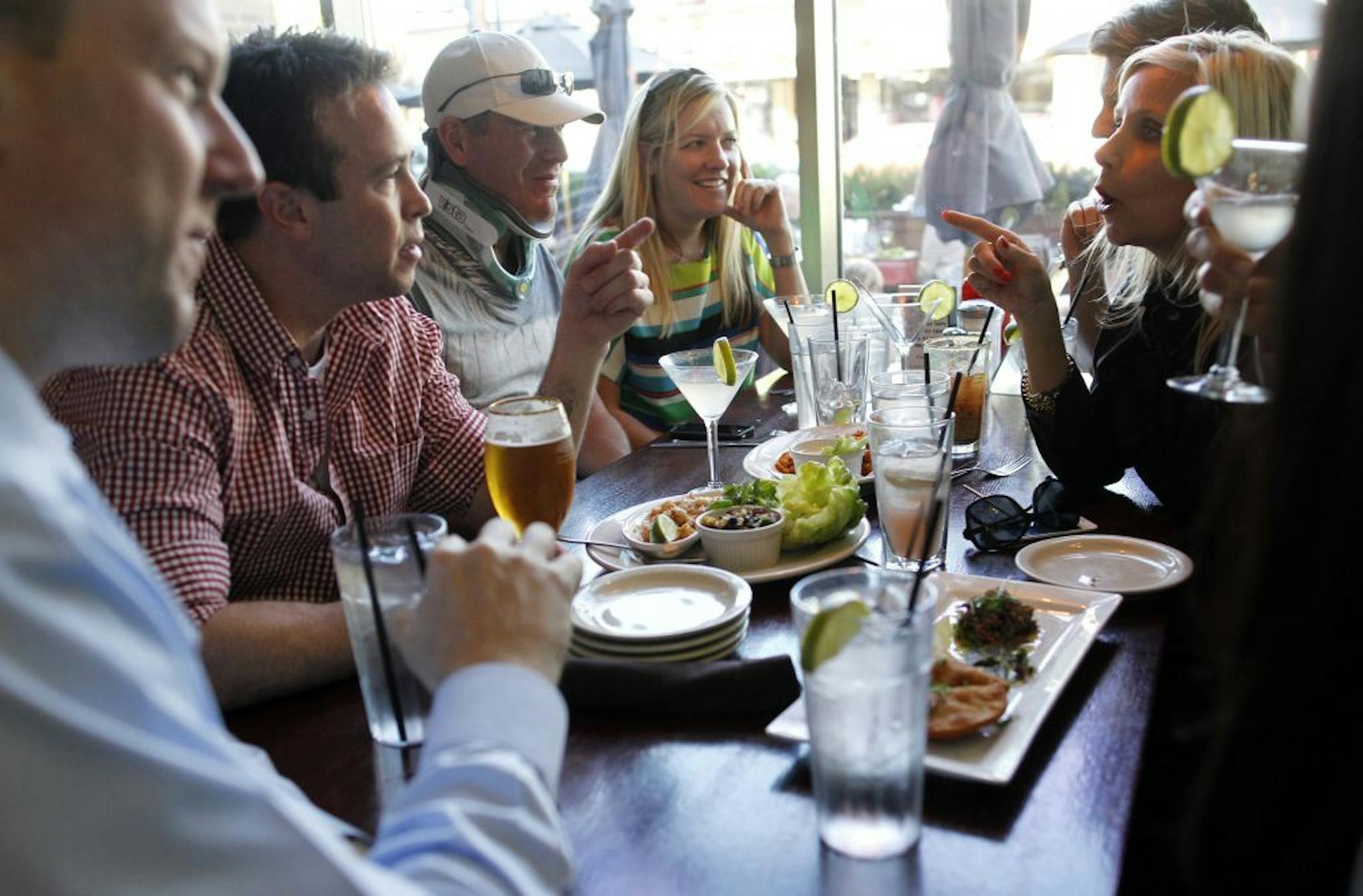Friends gather at the Edina Grill for the first "Happy Hour" in Edina. Edina has never had happy hour in its bars and restaurants. After a change in the law, the restaurants at 50th and France will celebrate the very first happy hours ever in this suburb. Some of the bars are celebrating like it's the end of Prohibition with super cheap cocktails [ TOM WALLACE • twallace@startribune.com _ Assignments #20023344A_ May 10, 2012_ SLUG: night0518_ EXTRA INFORMATION: Names CQ'ed by folks in photo.