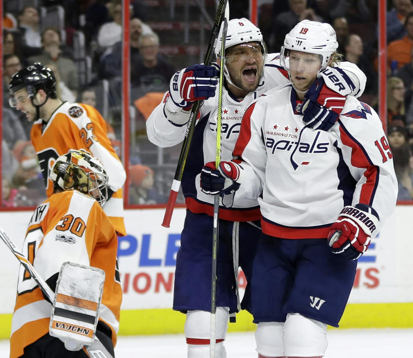 Washington Capitals' Alex Ovechkin (8) and Nicklas Backstrom (19) celebrate past Philadelphia Flyers' Michal Neuvirth (30) and Brandon Manning (23) after Backstrom's goal during the first period of an NHL hockey game, Wednesday, Feb. 22, 2017, in Philadelphia. (AP Photo/Matt Slocum)