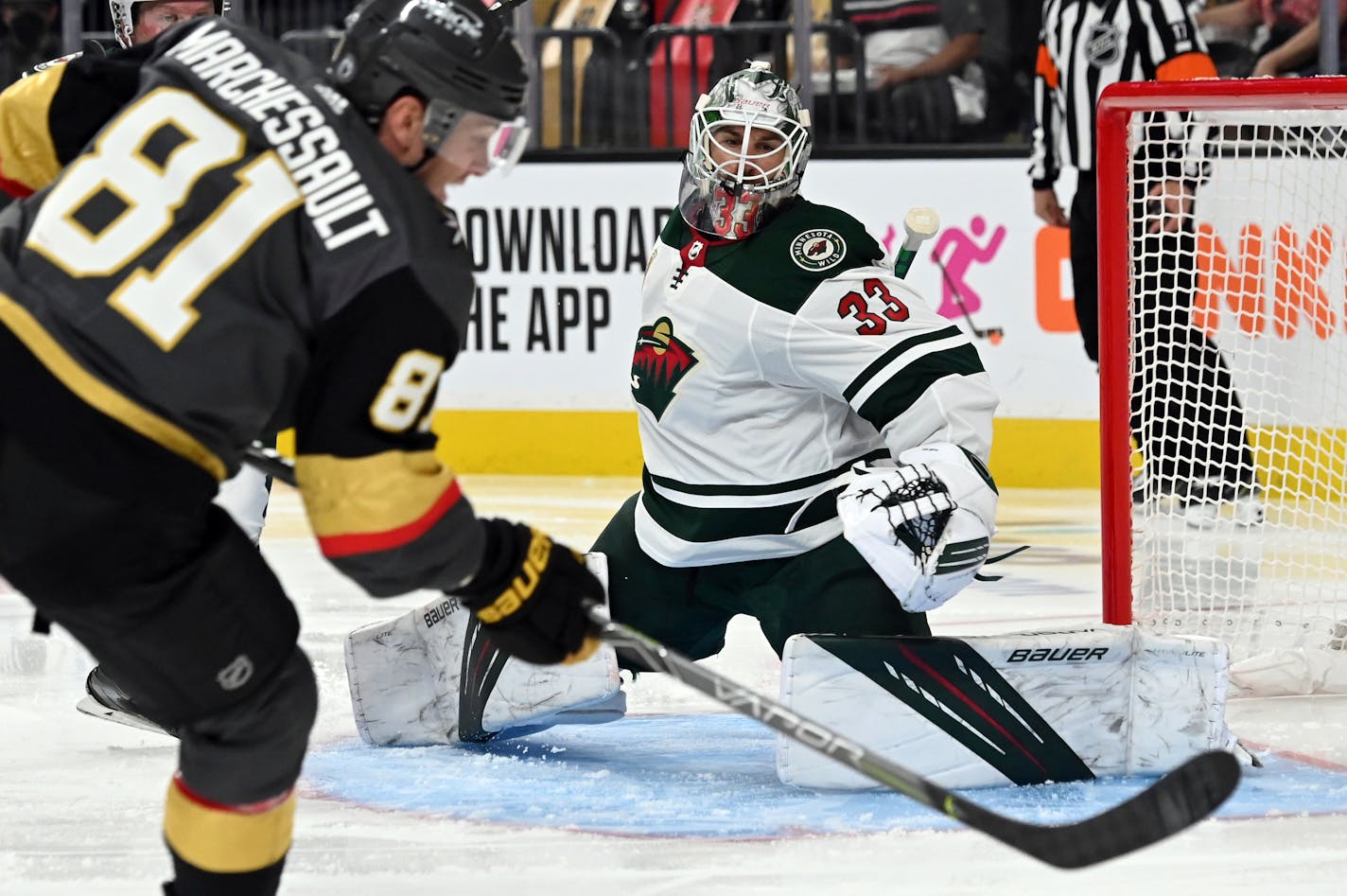 Minnesota Wild goaltender Cam Talbot (33) defends against a shot by Vegas Golden Knights center Jonathan Marchessault (81) during the second period of Game 1 of a first-round NHL hockey playoff series Sunday, May 16, 2021, in Las Vegas. (AP Photo/David Becker)