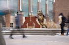 Students pass a statue of Goldy the gopher and the university’s logo during a class change Thursday, Jan. 18, 2024, at the University of Minnesota i