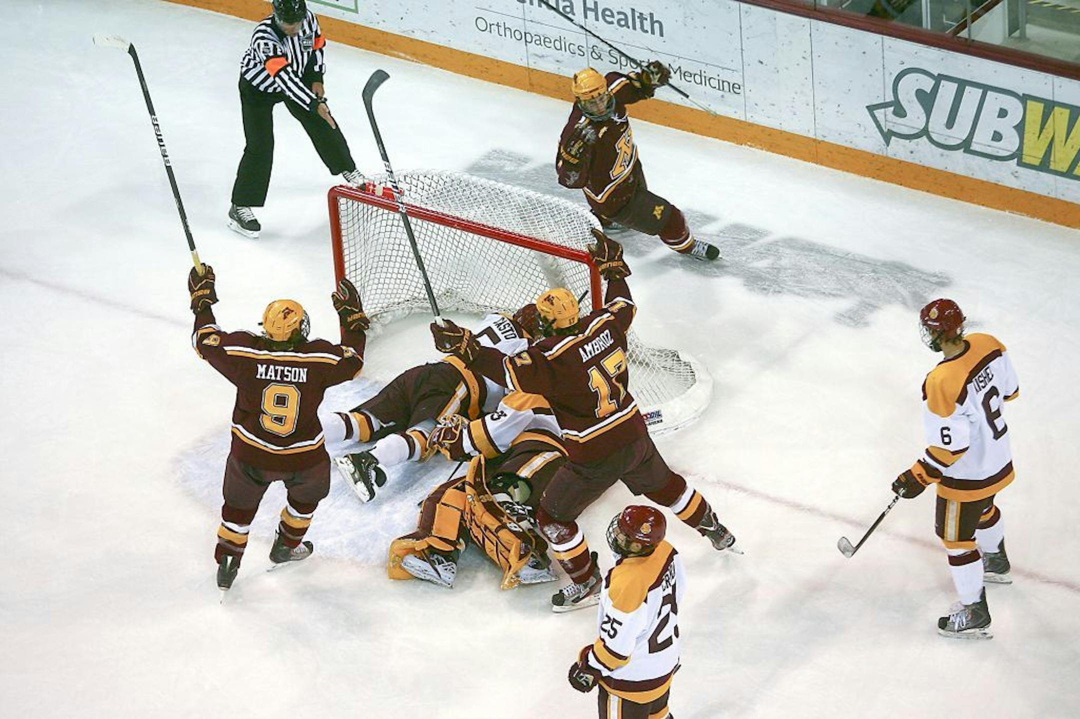 Gophers players celebrated after scoring a goal Saturday night in Duluth.