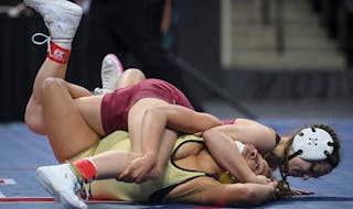 Forest Lake's Aspen Blasko tries to pin Fridley's Olivia Sackor in the 107lb final bout during the Minnesota State High School girls Wrestling Champio