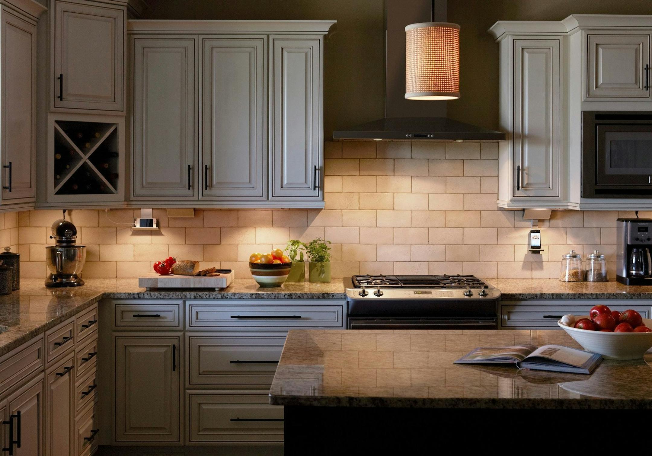 The adorne Under-Cabinet Lighting System combines power and lighting with iPad and iPhone docks, preserving space on your countertop. (Adorne/Charlotte Observer/MCT)