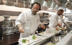 Chef Lenny Russo of Heartland Restaurant in downtown St. Paul preps salad in his kitchen.