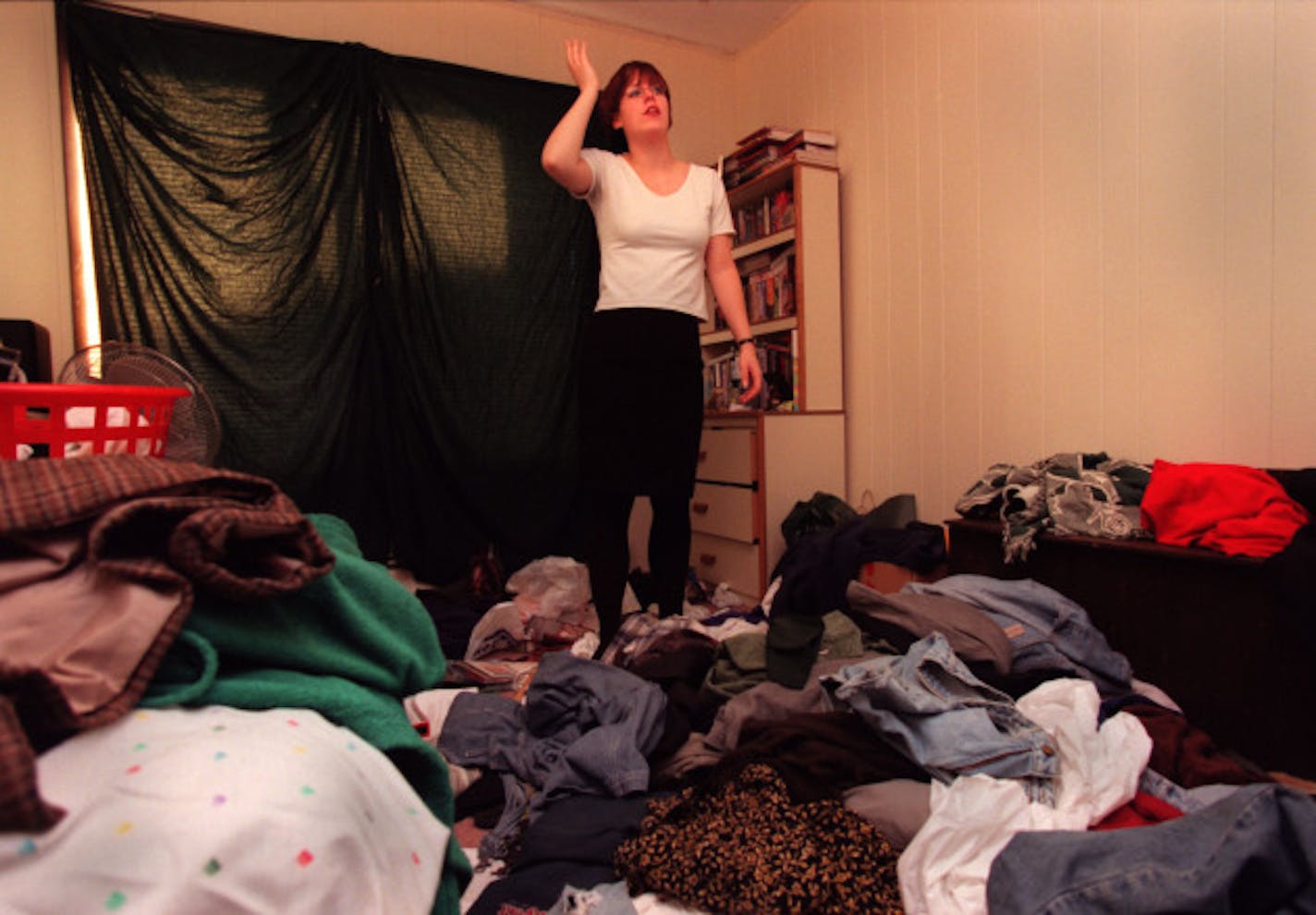 Hamline University senior Shannon Miller--entering the real world from college. -- Shannon Miller's room shows a buildup of laundry on the floor.